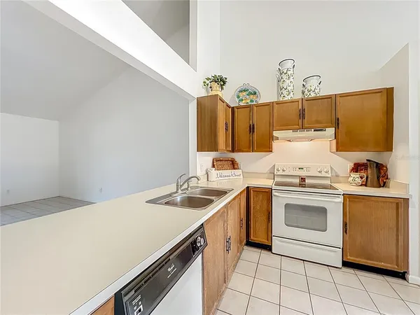 a kitchen with a stove sink and cabinets