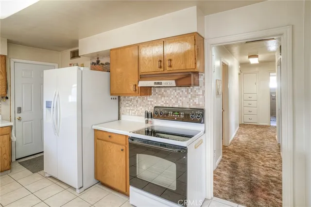 a kitchen with stainless steel appliances granite countertop a refrigerator and a stove