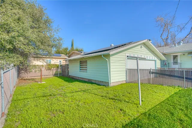 a view of a backyard with a garden and entertaining space
