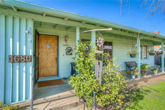 a front view of a house with outdoor seating