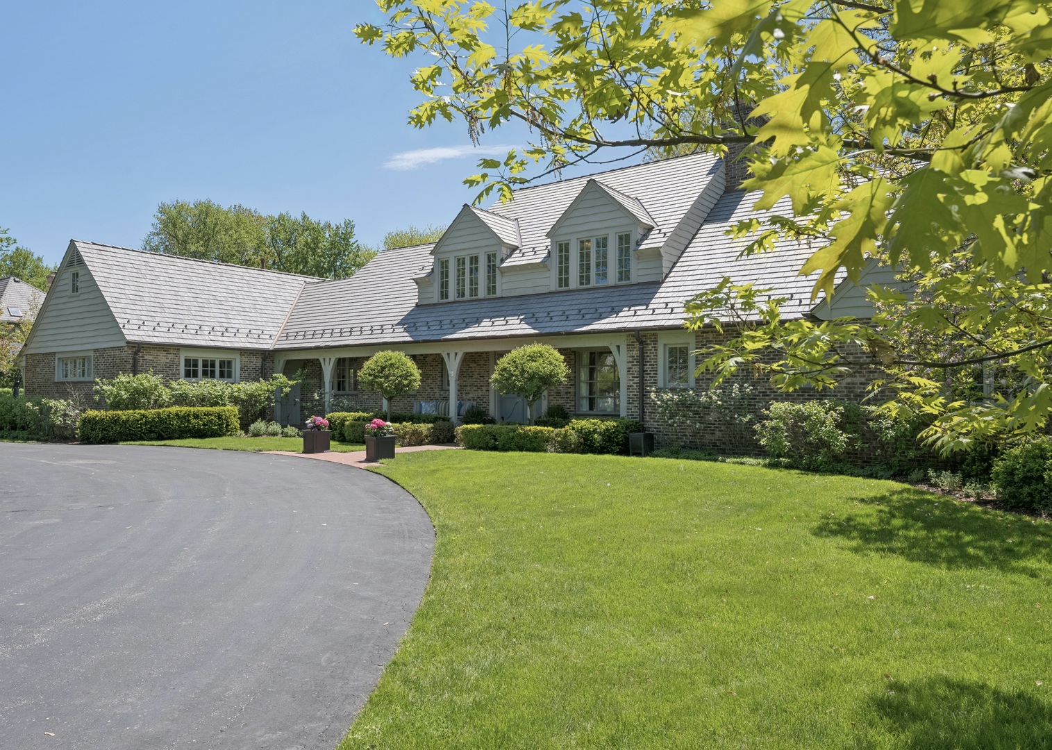 936 Sunset Road Winnetka, IL 60093 - Photo 1 of 50 a view of a house with a yard and potted plants
