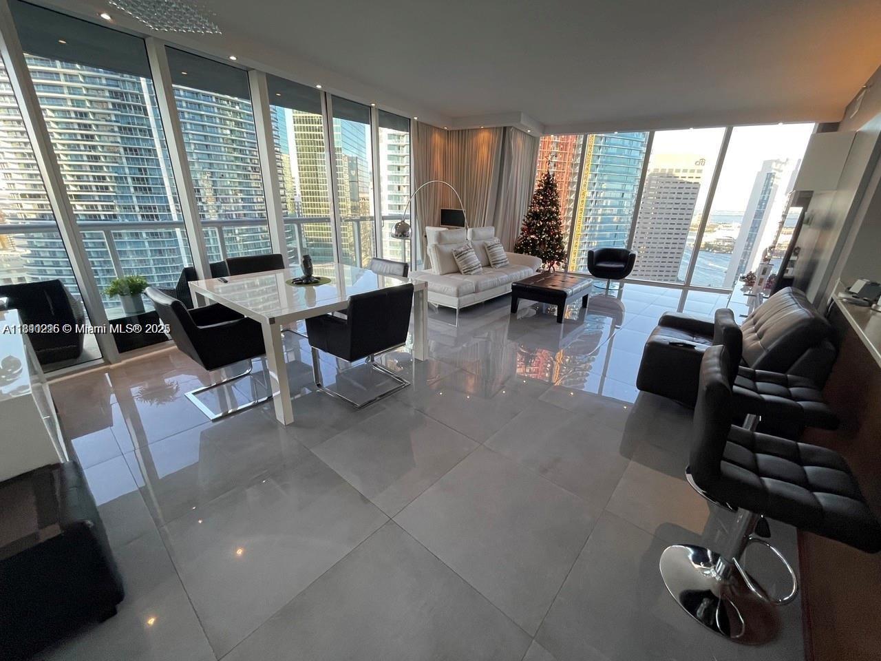 Icon Brickell Miami, FL 33131 - Photo 2 of 12 a living room with furniture and a floor to ceiling window