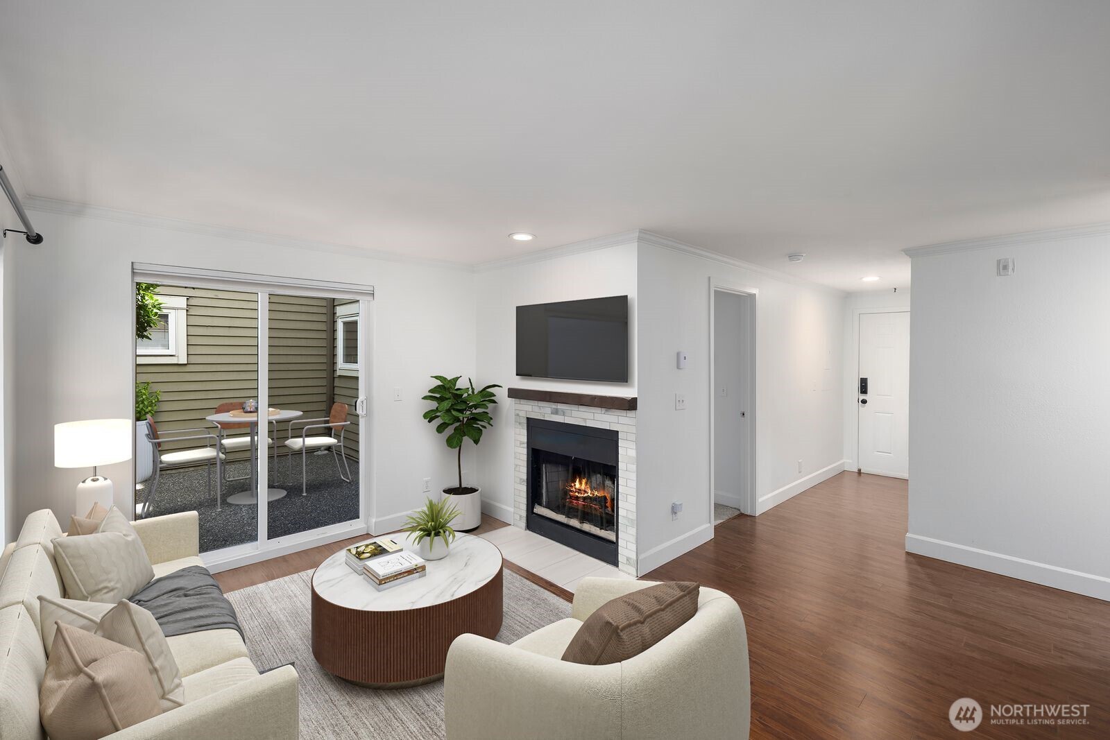 3901 Fremont Avenue North, Unit 202 Seattle, WA 98103 - Photo 3 of 23 a living room with furniture a fireplace and a large window