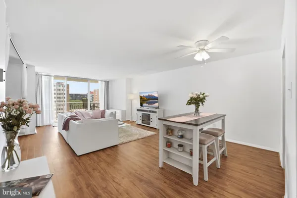 a living room with furniture wooden floor and a window