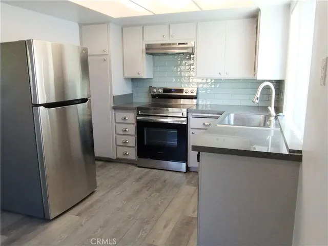 a kitchen with granite countertop a stove and a sink