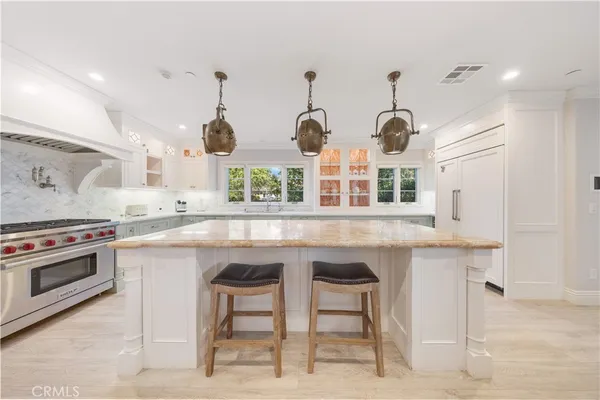 a kitchen with stainless steel appliances granite countertop a stove and a sink