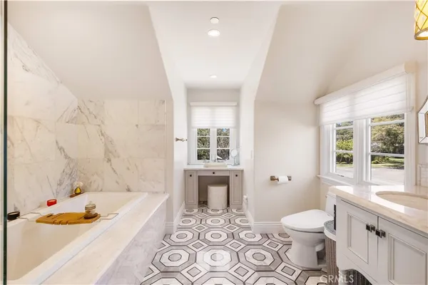 a bathroom with a tub shower and a sink