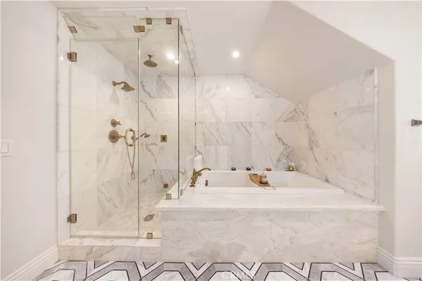 a bathroom with a tub sink and mirror