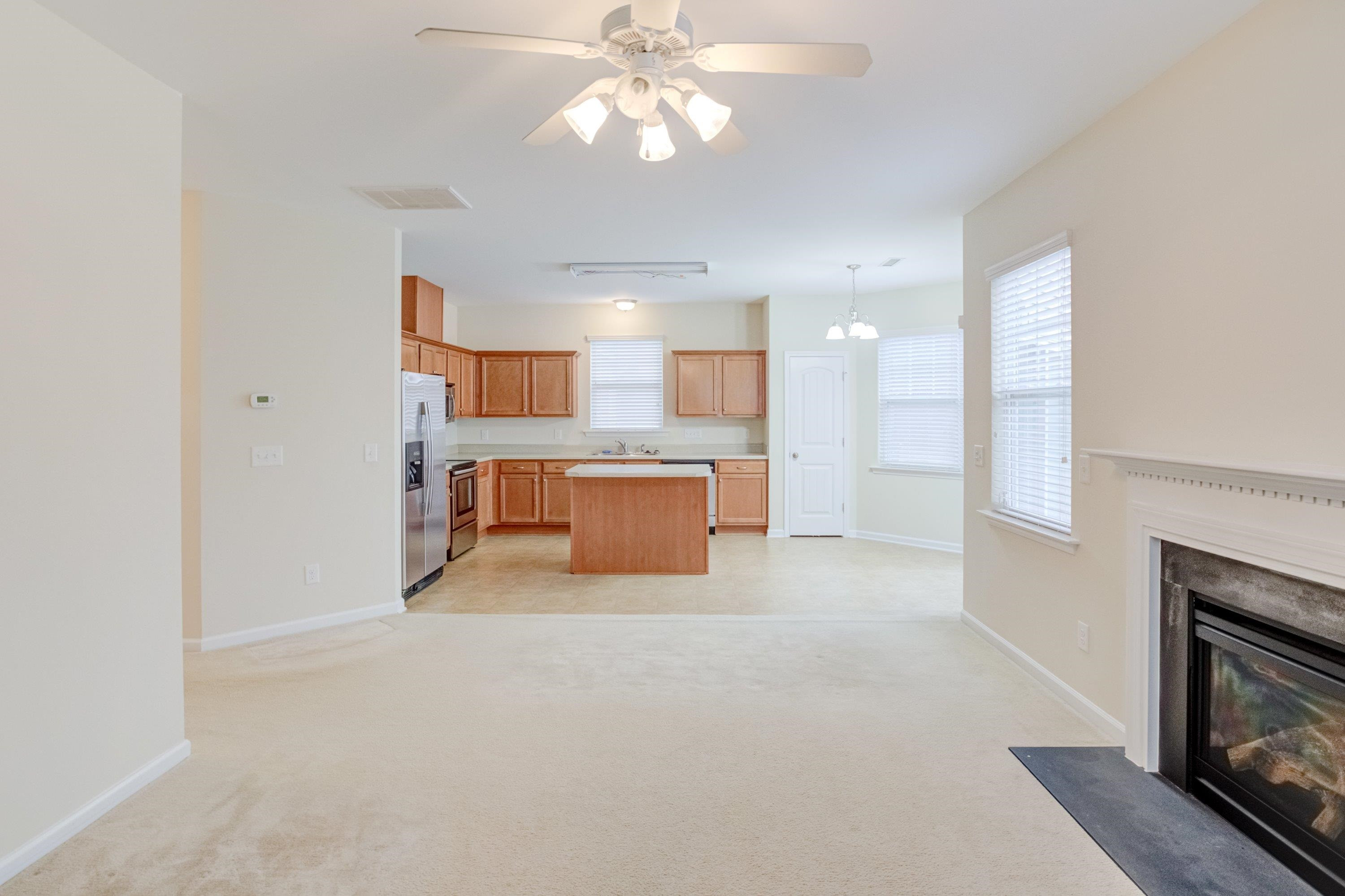 409 Birchrun Drive Durham, NC 27712 - Photo 14 of 49 a large white kitchen with a fireplace a sink and dishwasher