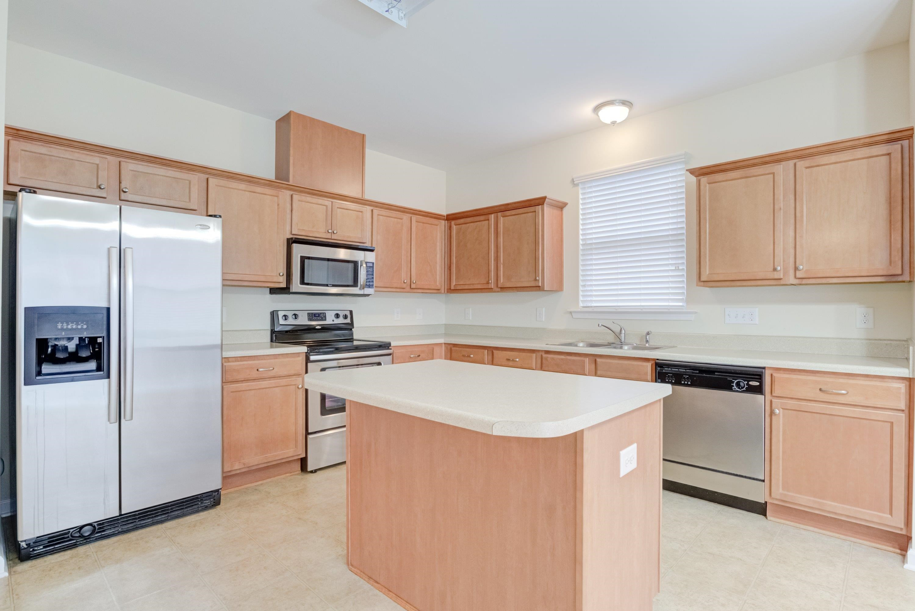 409 Birchrun Drive Durham, NC 27712 - Photo 16 of 49 a kitchen with stainless steel appliances granite countertop a refrigerator sink and microwave