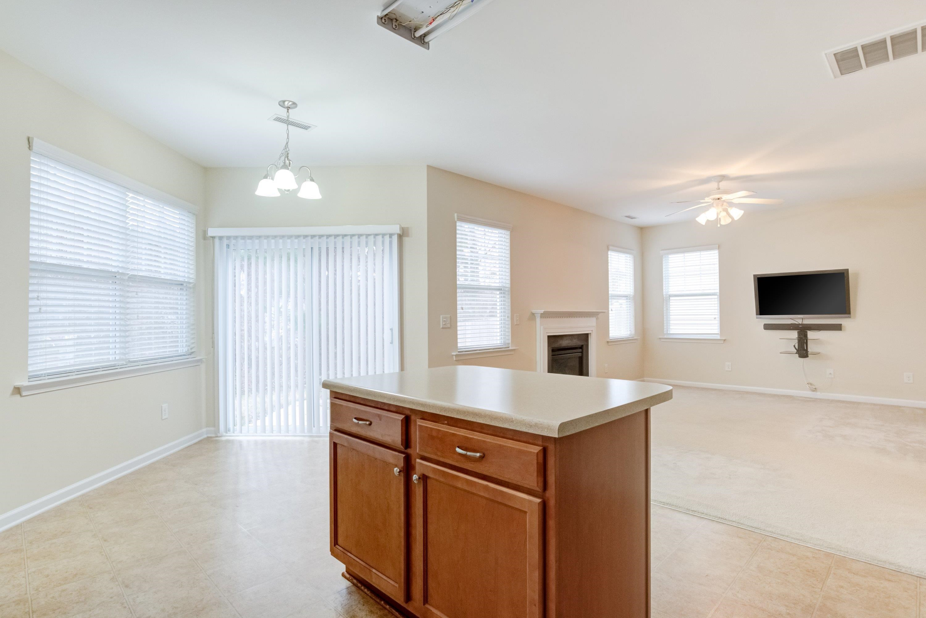 409 Birchrun Drive Durham, NC 27712 - Photo 18 of 49 a room with a sink furniture and a flat screen tv
