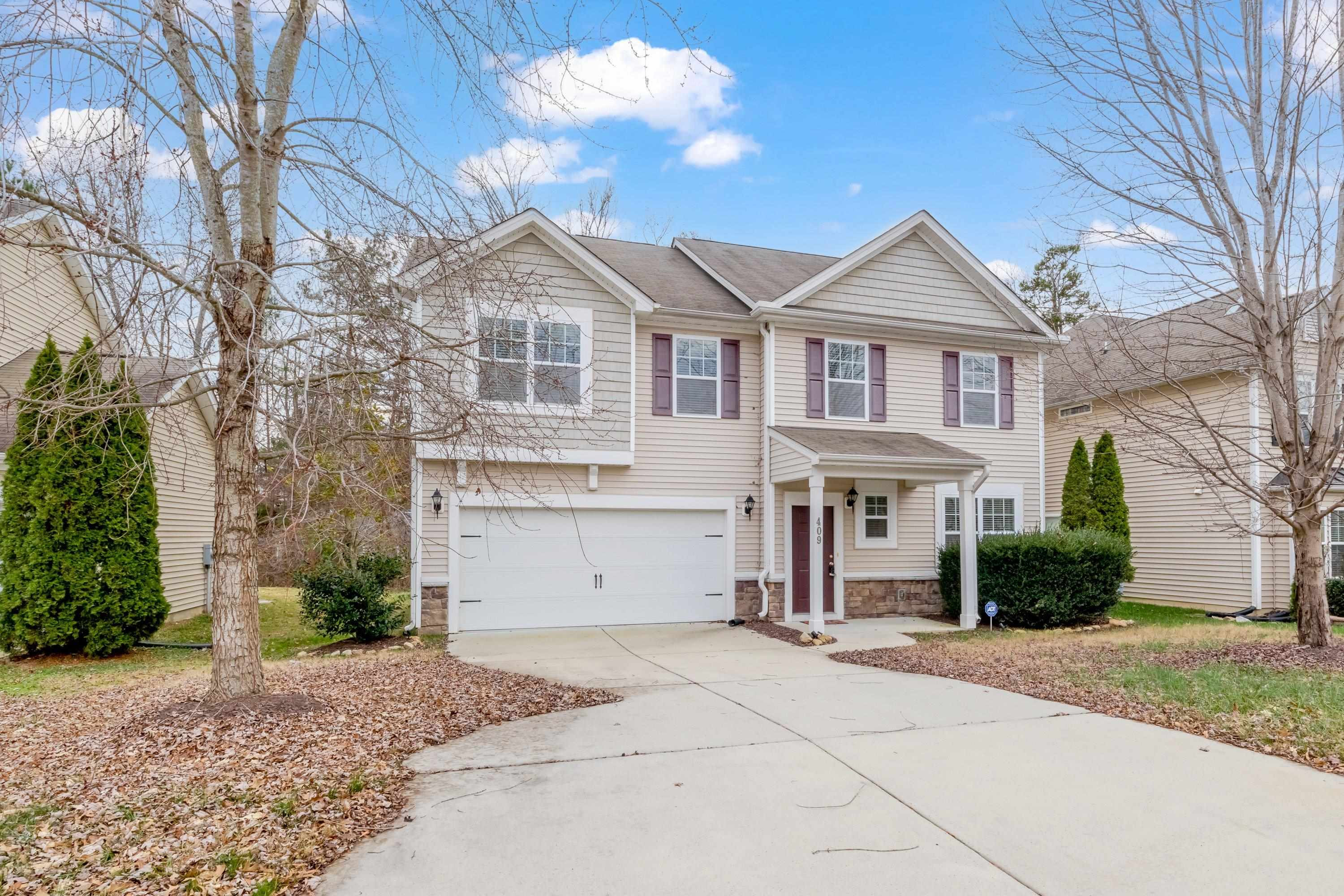 409 Birchrun Drive Durham, NC 27712 - Photo 2 of 49 a front view of a house with a yard and garage