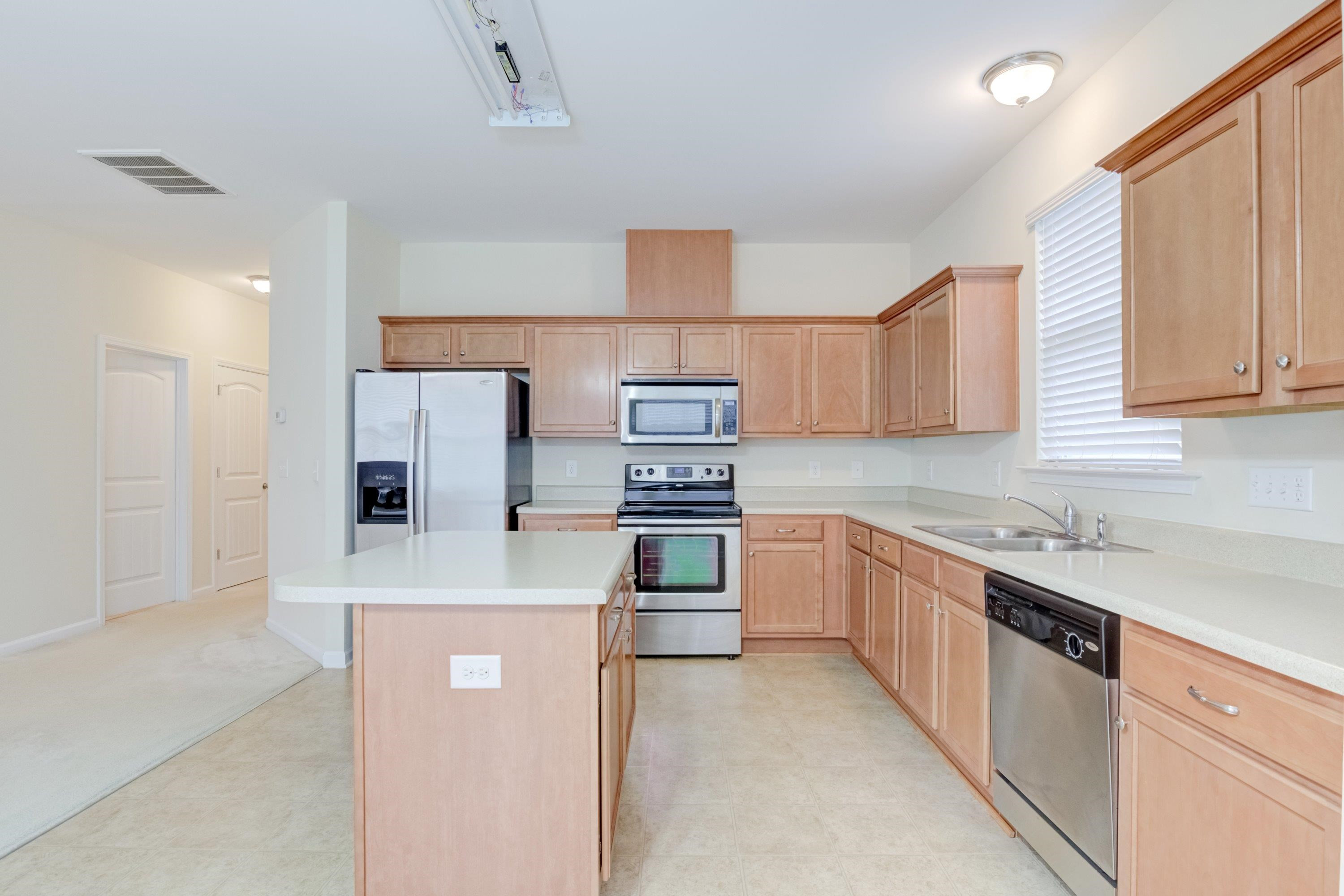 409 Birchrun Drive Durham, NC 27712 - Photo 21 of 49 a kitchen with stainless steel appliances granite countertop a stove a sink and a refrigerator