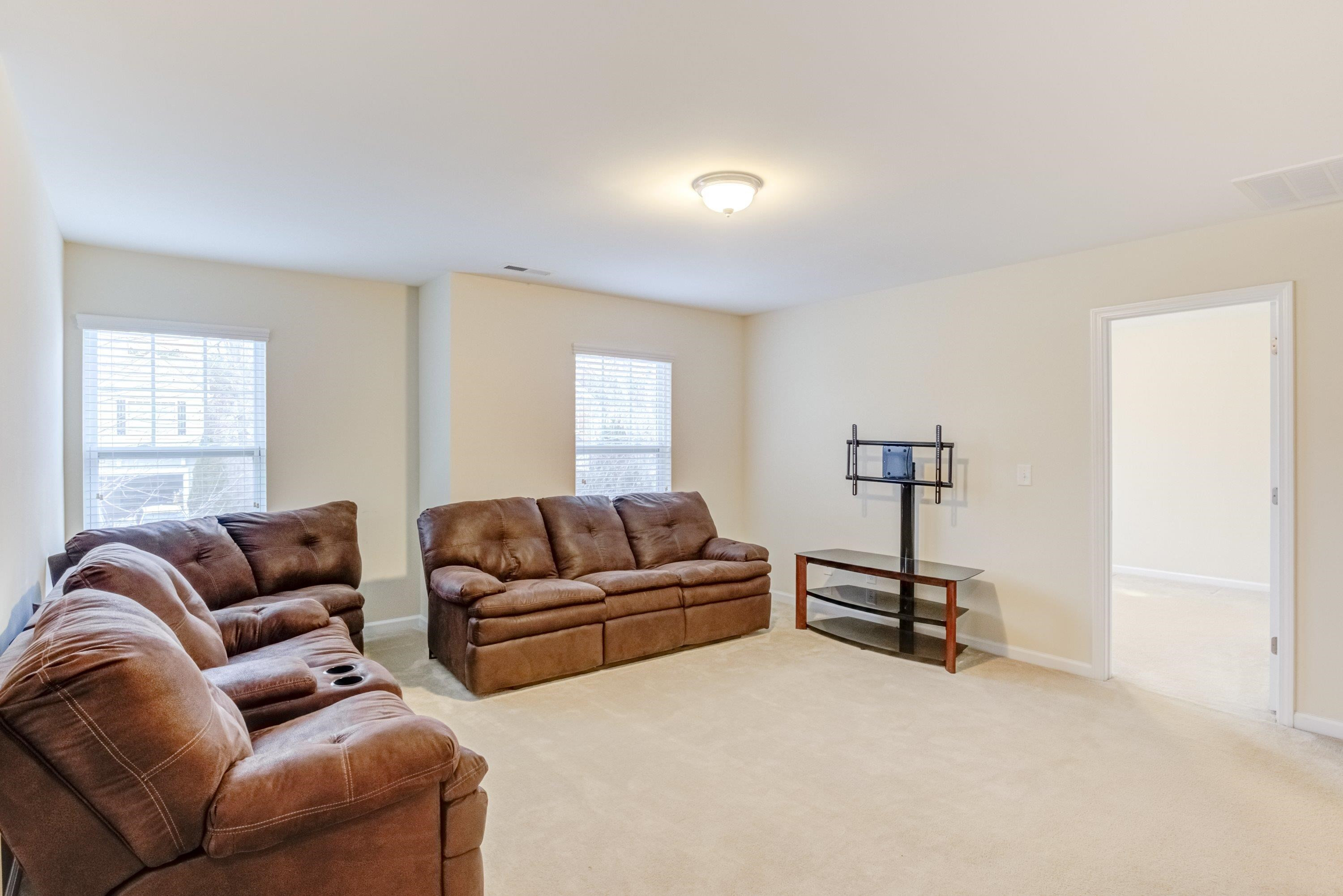 409 Birchrun Drive Durham, NC 27712 - Photo 23 of 49 a living room with furniture a air conditioner vent and a window
