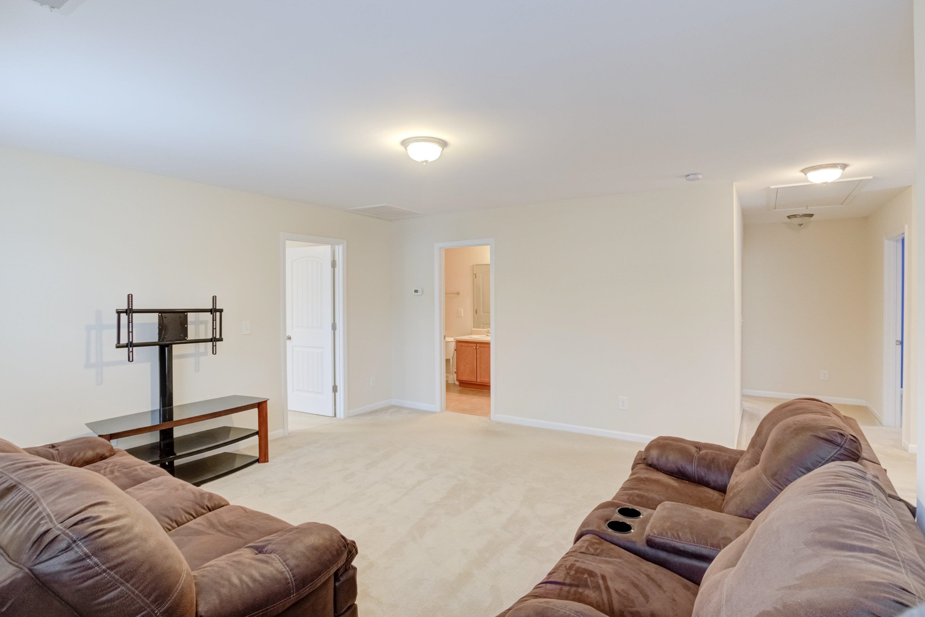409 Birchrun Drive Durham, NC 27712 - Photo 24 of 49 a living room with furniture and a lamp