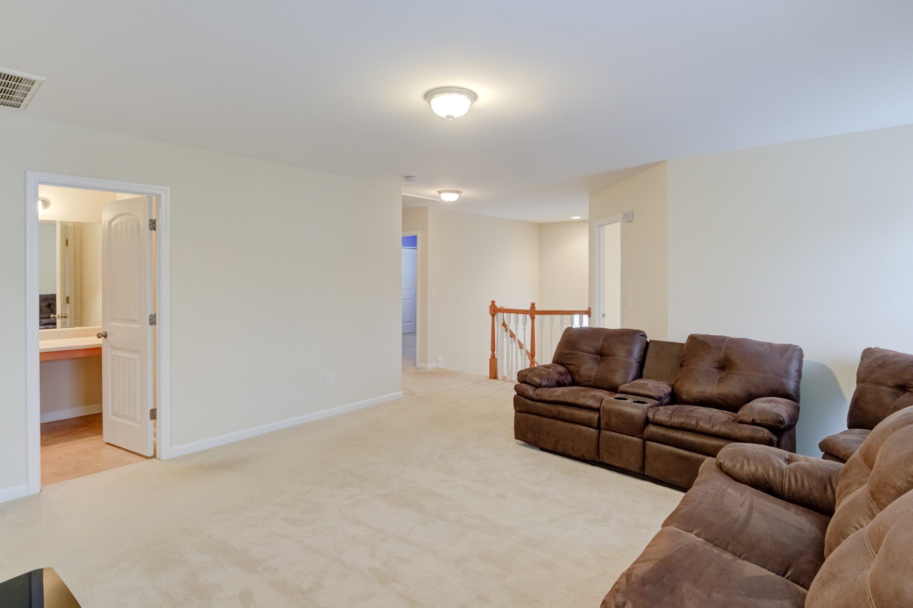 409 Birchrun Drive Durham, NC 27712 - Photo 25 of 49 a living room with furniture and a walk in closet with wooden floor