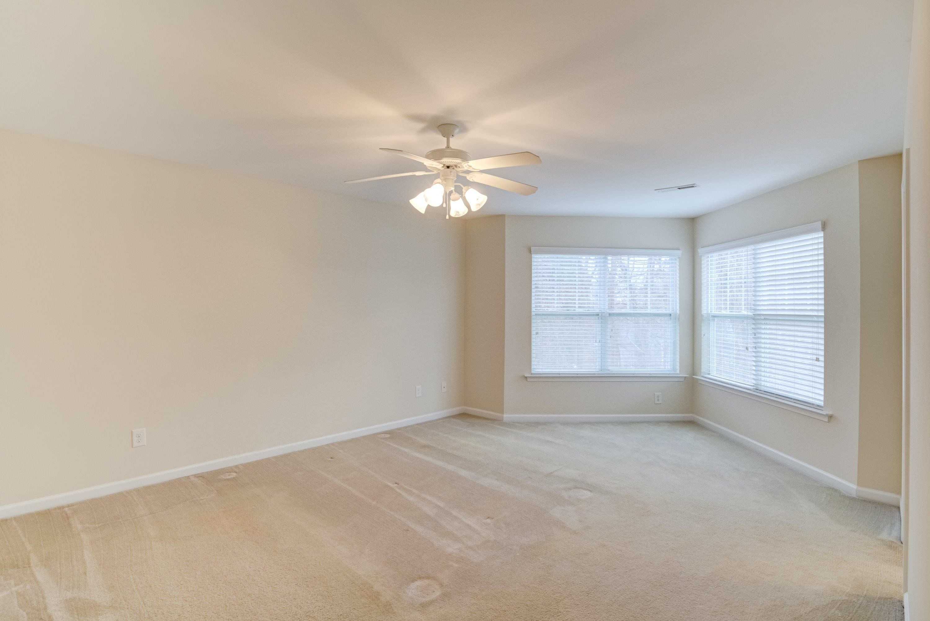 409 Birchrun Drive Durham, NC 27712 - Photo 27 of 49 an empty room with chandelier fan and windows