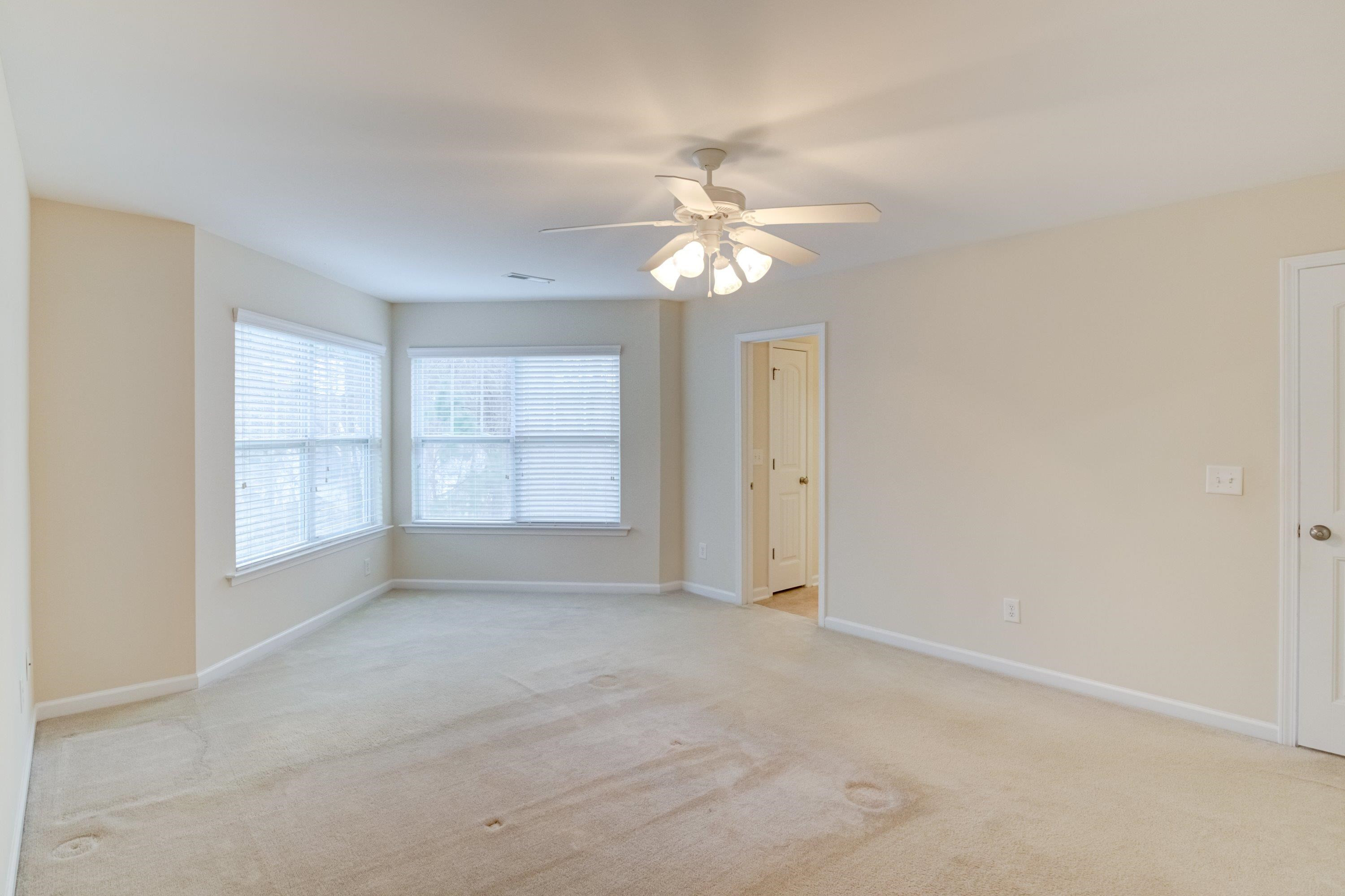 409 Birchrun Drive Durham, NC 27712 - Photo 29 of 49 an empty room with chandelier fan and windows