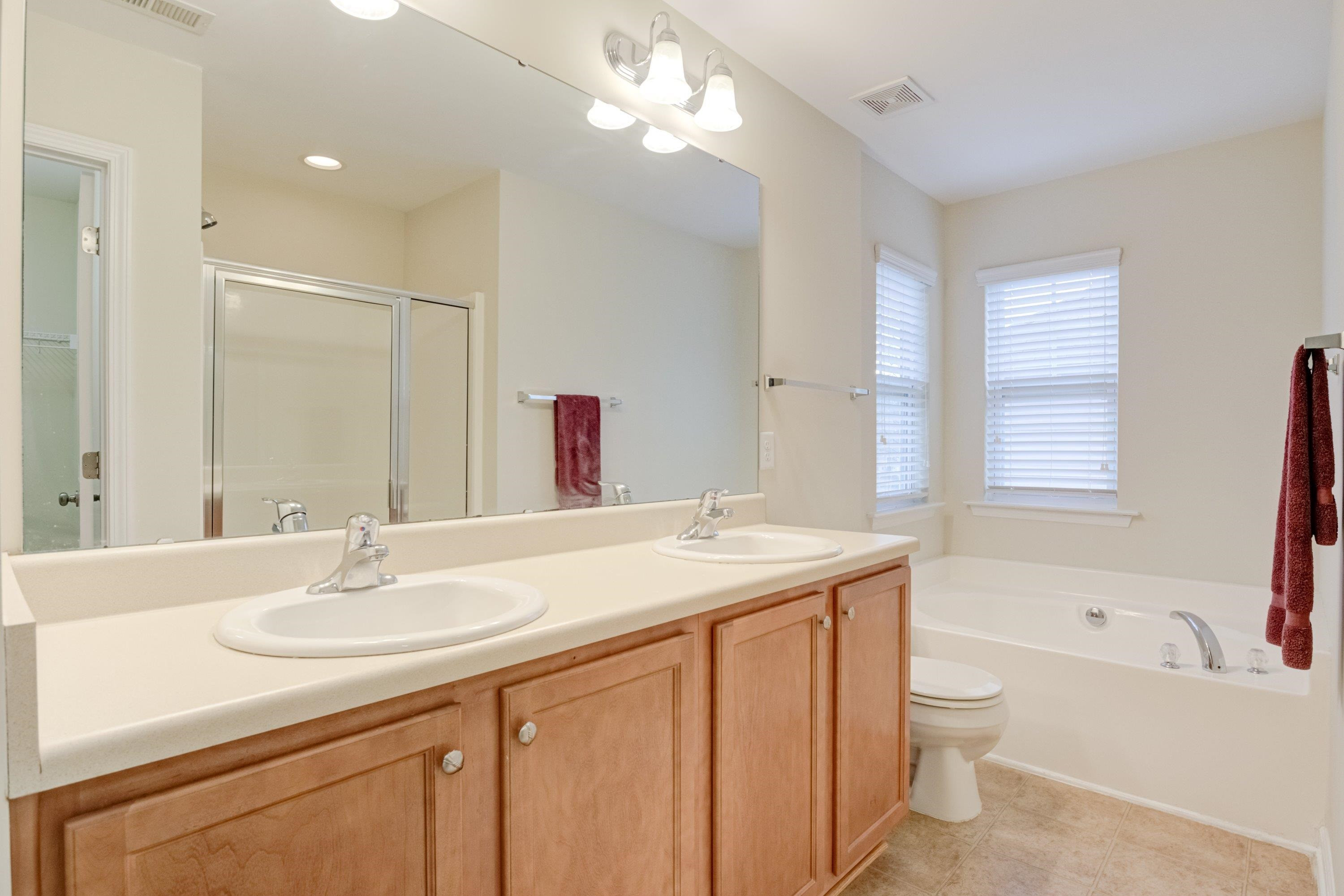 409 Birchrun Drive Durham, NC 27712 - Photo 31 of 49 a bathroom with a sink double vanity granite tub and a mirror