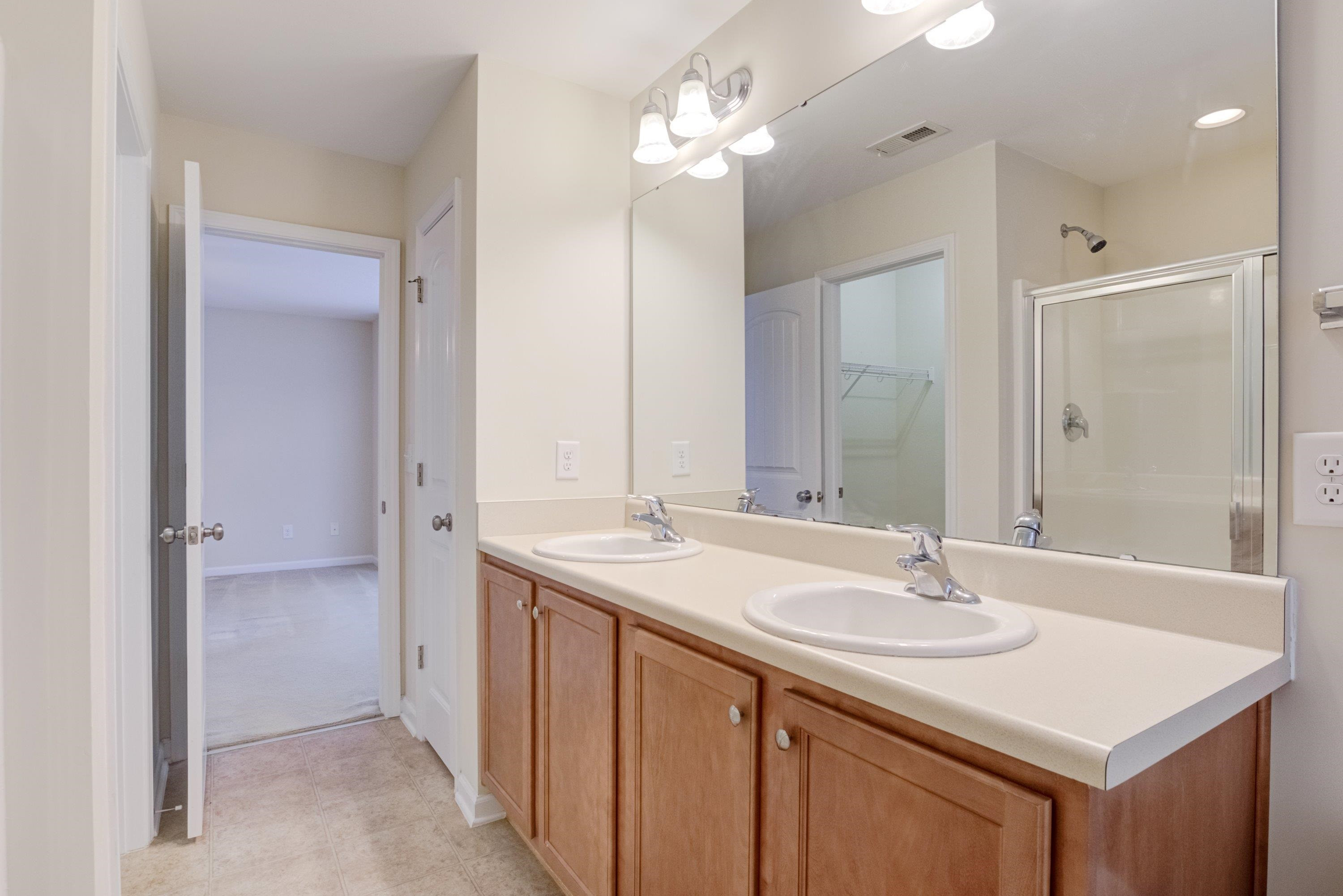 409 Birchrun Drive Durham, NC 27712 - Photo 32 of 49 a bathroom with a sink double vanity and a mirror