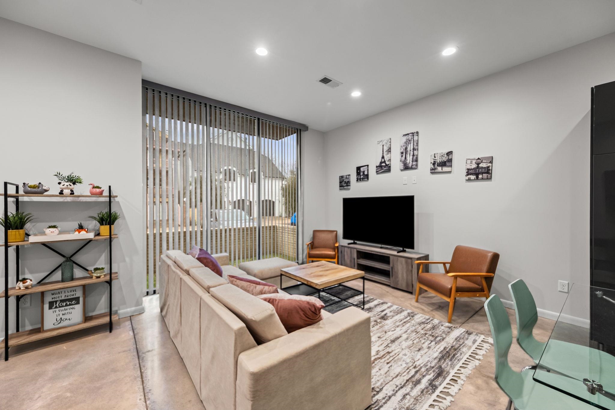 448 Tennessee Street Memphis, TN 38103 - Photo 37 of 39 Spacious living area featuring polished concrete flooring, recessed lighting, and expansive windows with vertical blinds