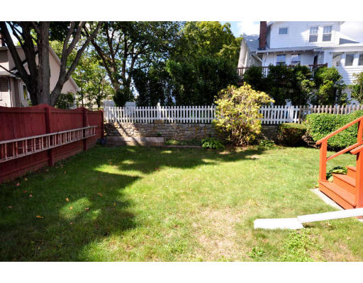 39 Inverness Road Arlington, MA 02476 - Photo 13 of 19 a garden view with swimming pool and trees in the background