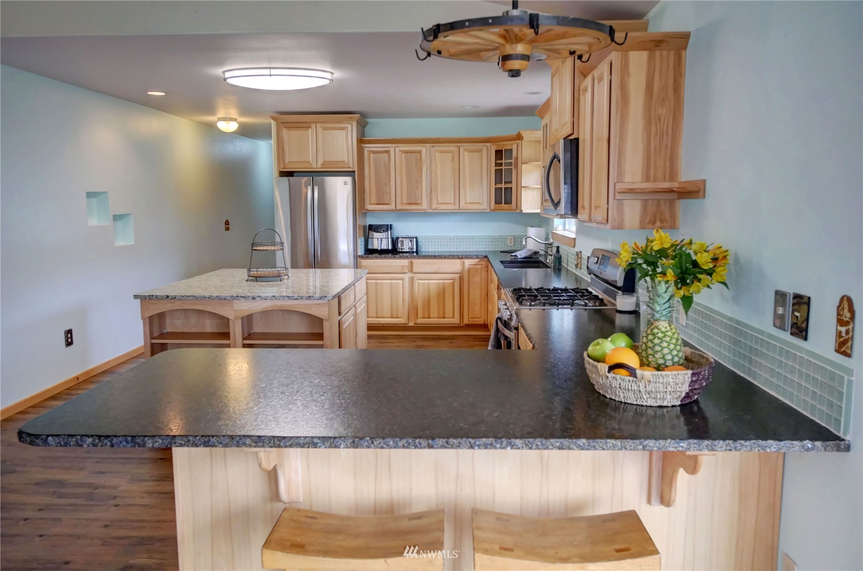 196 Pharr Road Riverside, WA 98849 - Photo 12 of 40 a kitchen with a sink a stove and chairs