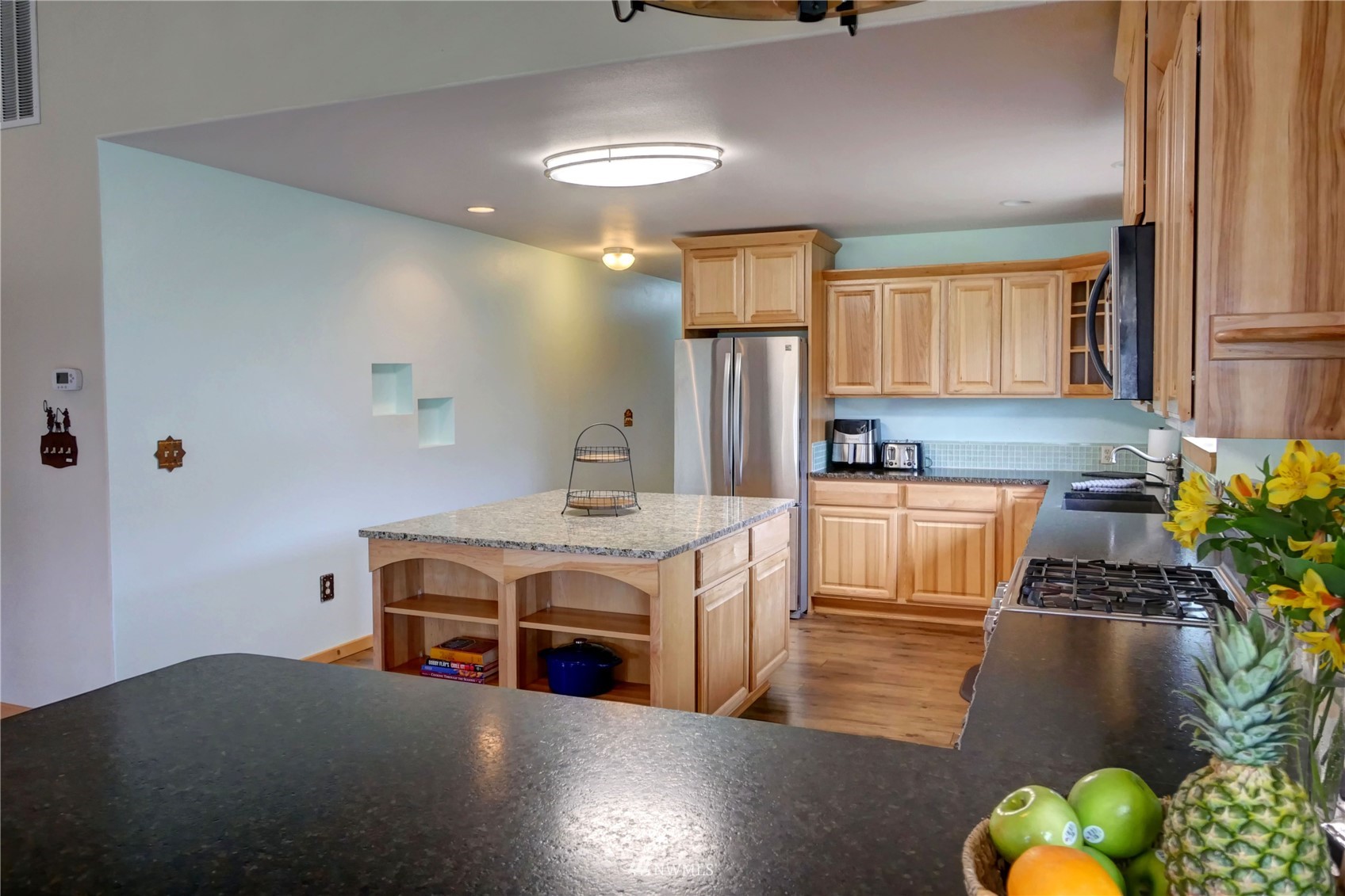 196 Pharr Road Riverside, WA 98849 - Photo 13 of 40 a kitchen with stainless steel appliances granite countertop a stove a sink dishwasher and a refrigerator with wooden floor