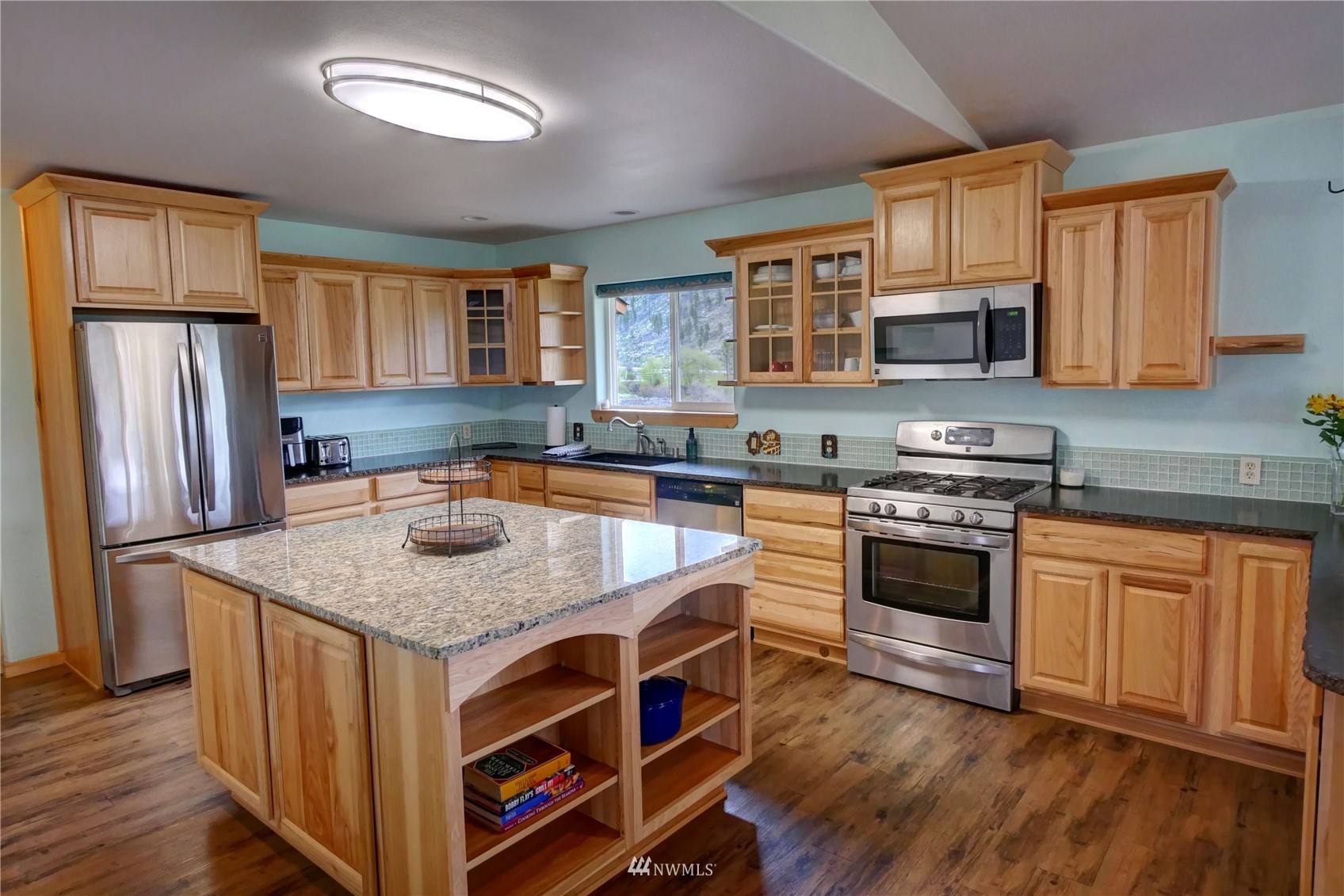 196 Pharr Road Riverside, WA 98849 - Photo 14 of 40 a kitchen with stainless steel appliances granite countertop a stove a sink and a refrigerator