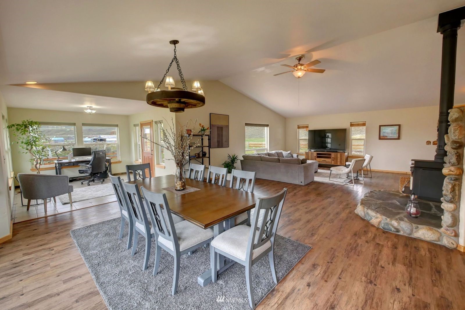 196 Pharr Road Riverside, WA 98849 - Photo 18 of 40 a dining room with wooden floor a chandelier a wooden table and chairs