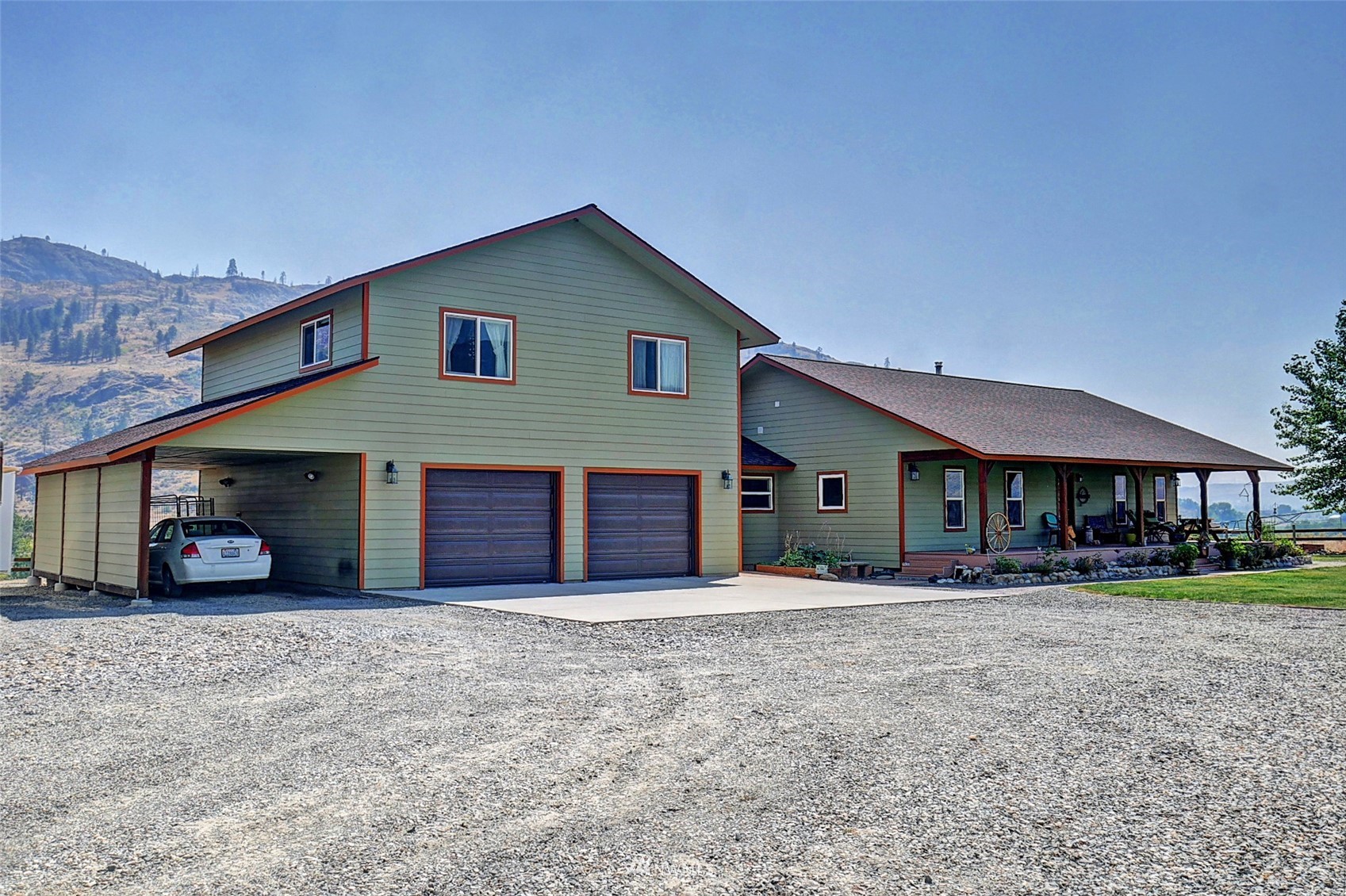 196 Pharr Road Riverside, WA 98849 - Photo 2 of 40 a front view of a house with a yard and garage