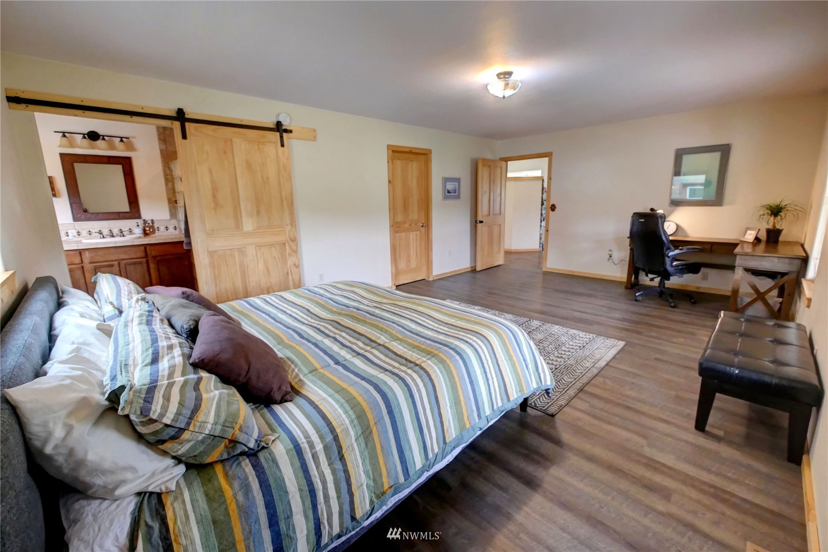 196 Pharr Road Riverside, WA 98849 - Photo 24 of 40 a bedroom with a bed and wooden floor