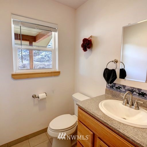 196 Pharr Road Riverside, WA 98849 - Photo 30 of 40 a bathroom with a granite countertop sink mirror and toilet