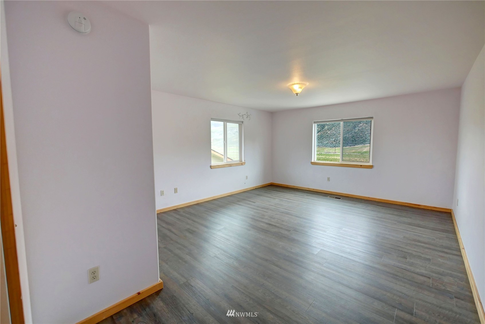 196 Pharr Road Riverside, WA 98849 - Photo 31 of 40 an empty room with wooden floor and windows