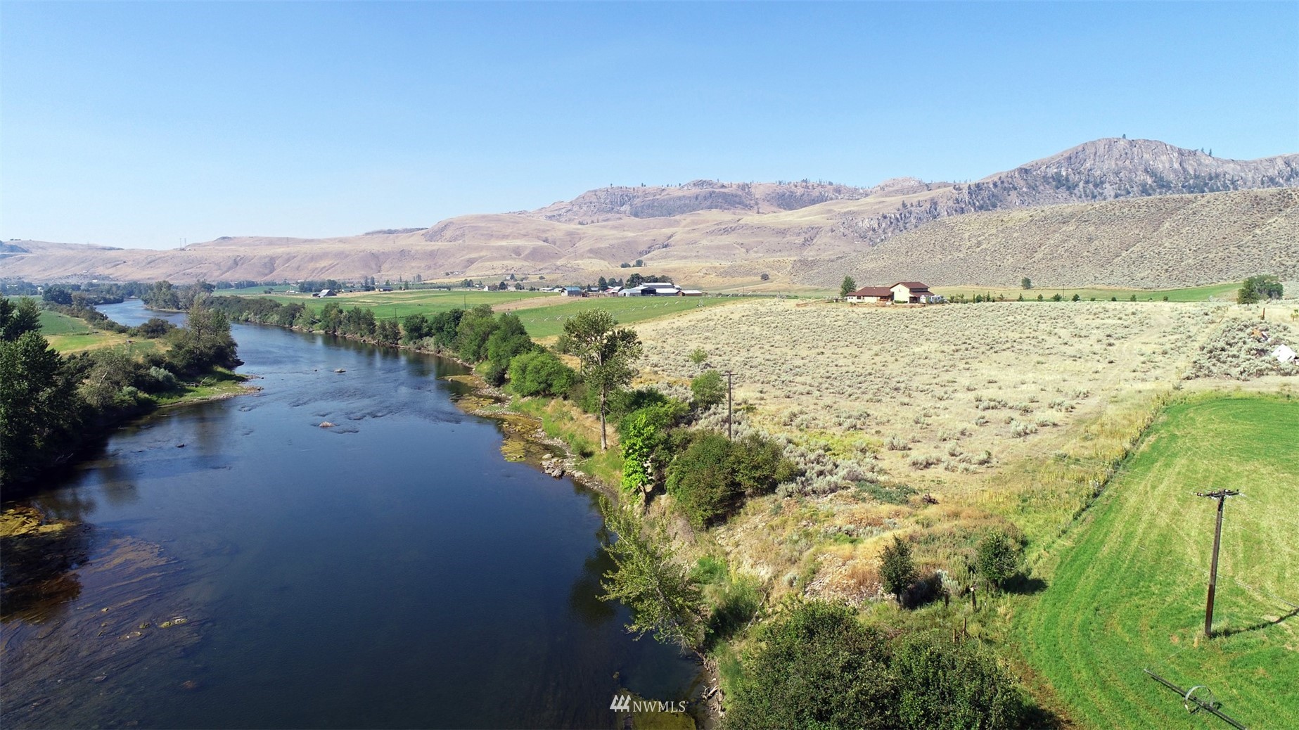 196 Pharr Road Riverside, WA 98849 - Photo 7 of 40 a view of a lake with mountains in the background