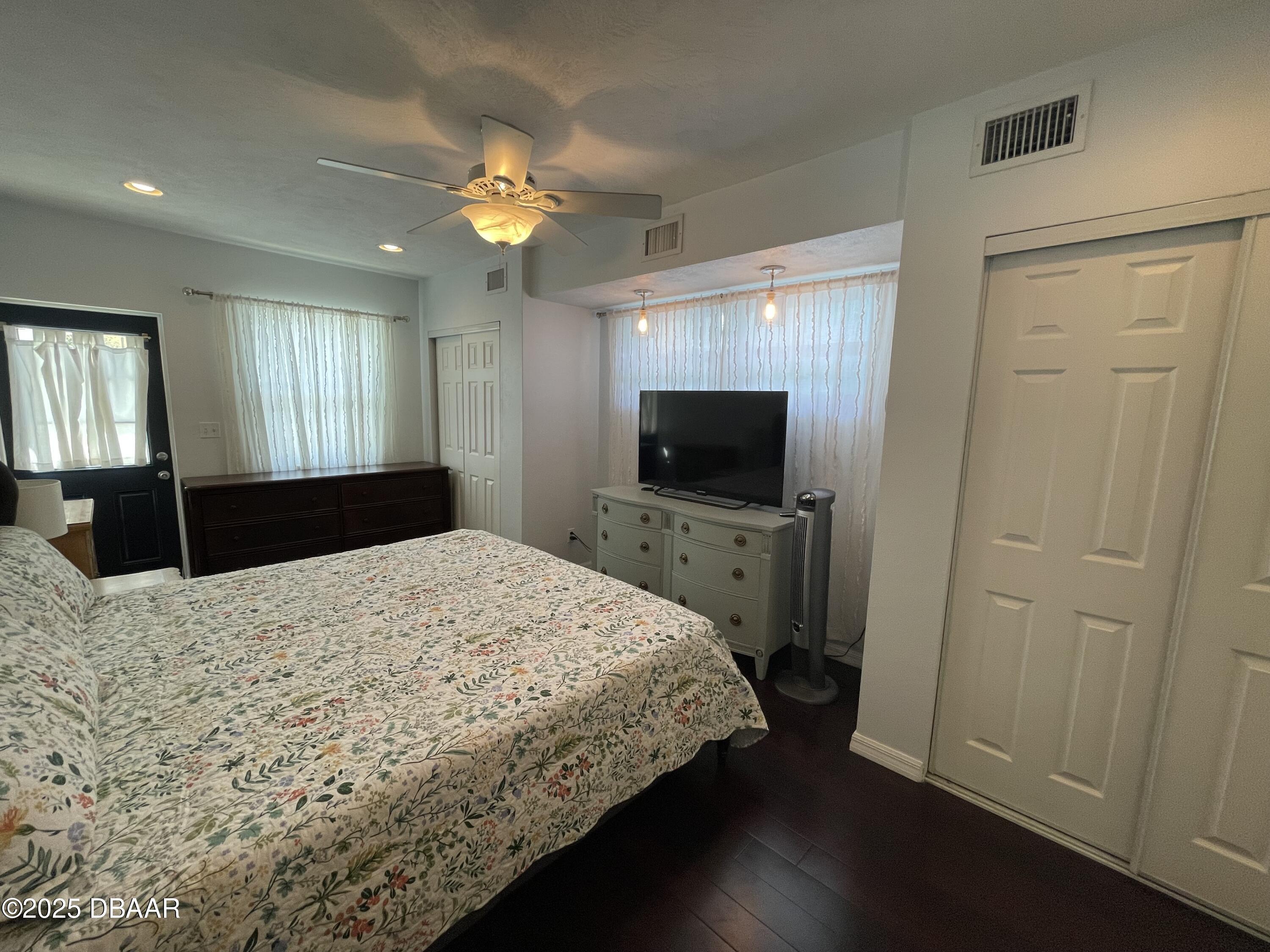 43 Warwick Avenue Ormond Beach, FL 32174 - Photo 11 of 32 a bedroom with a bed and a flat tv screen on dresser
