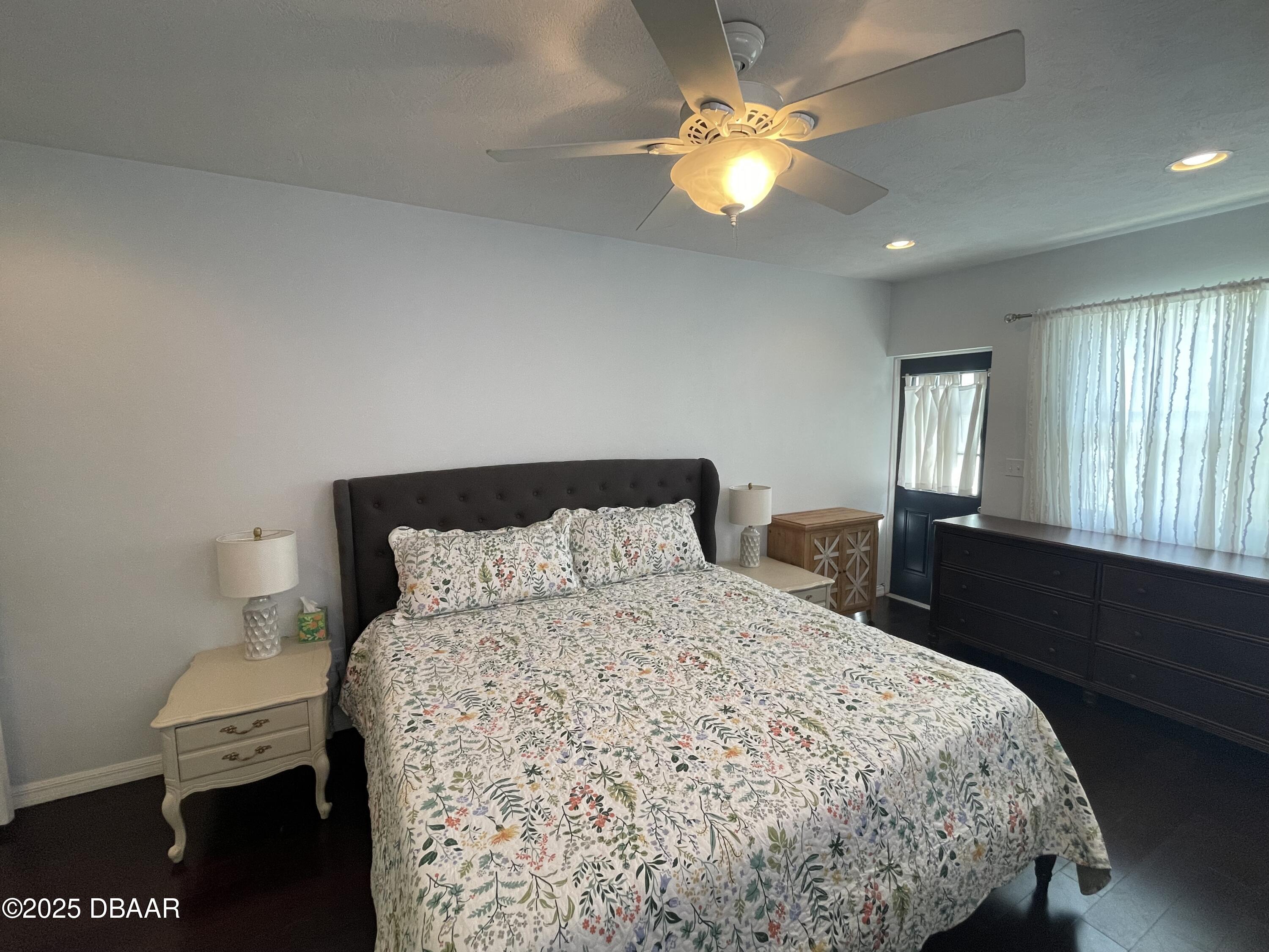 43 Warwick Avenue Ormond Beach, FL 32174 - Photo 12 of 32 a bedroom with a bed and a chandelier