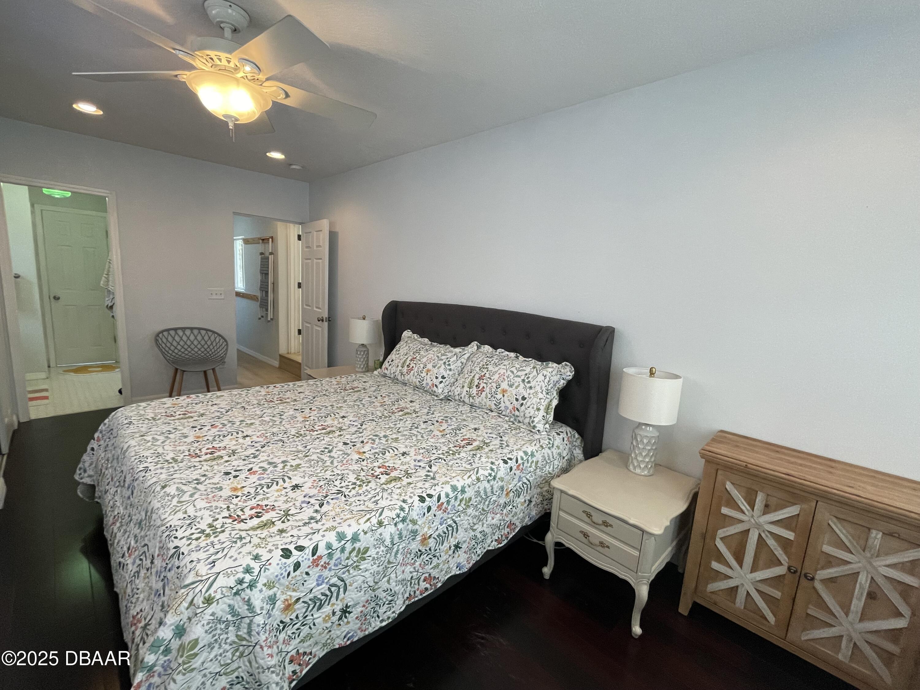 43 Warwick Avenue Ormond Beach, FL 32174 - Photo 13 of 32 a bedroom with a bed and closet with wooden floor