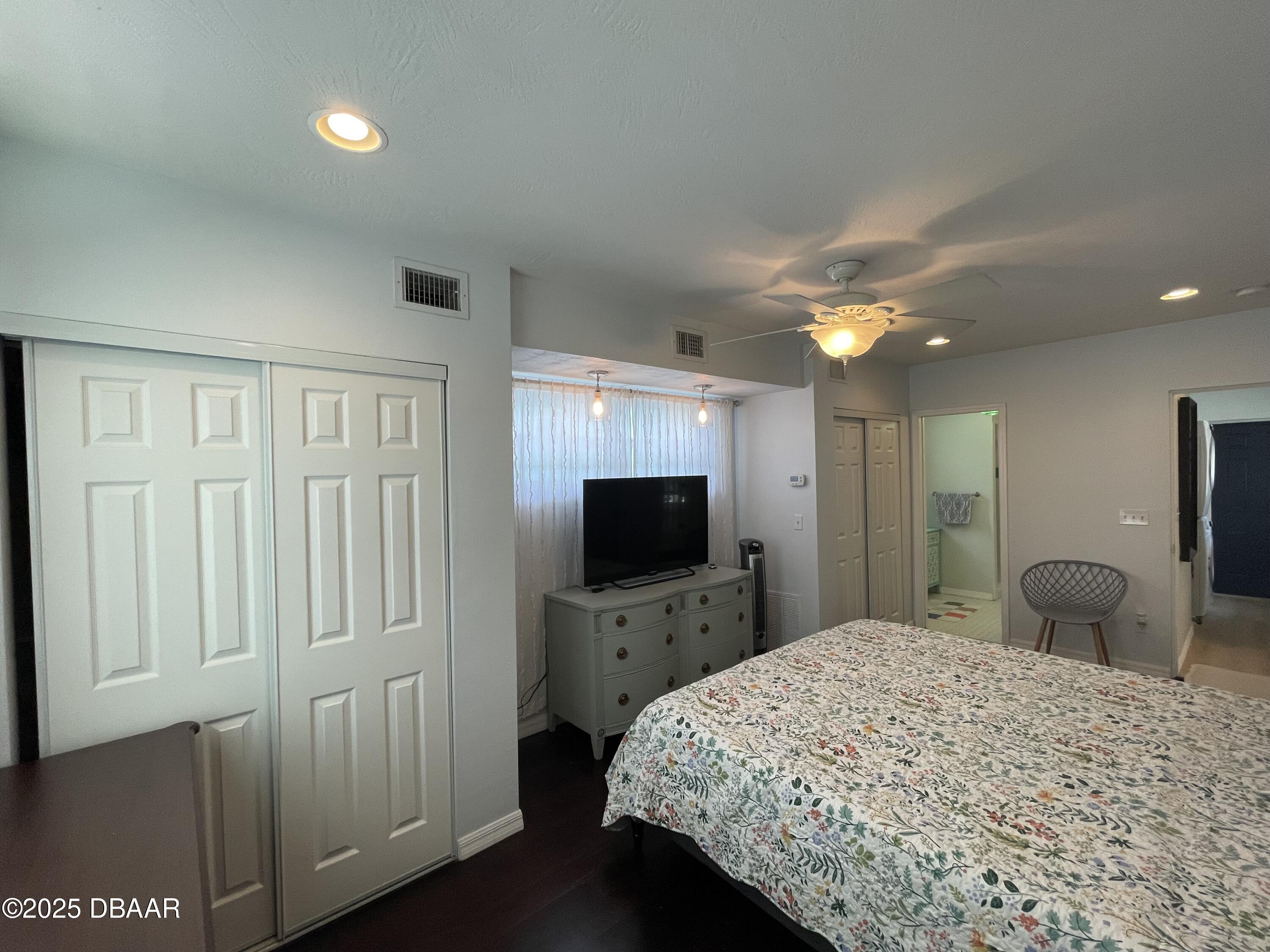 43 Warwick Avenue Ormond Beach, FL 32174 - Photo 14 of 32 a bedroom with a bed and a flat tv screen on wall