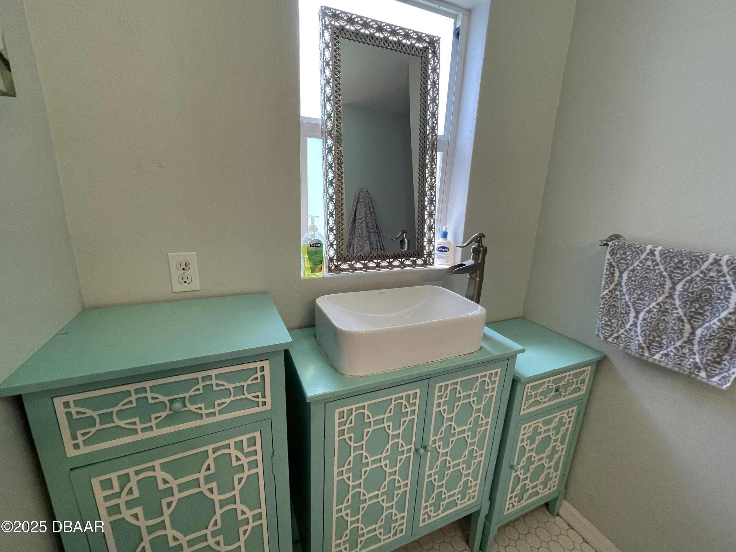 43 Warwick Avenue Ormond Beach, FL 32174 - Photo 15 of 32 a bathroom with a sink and a mirror