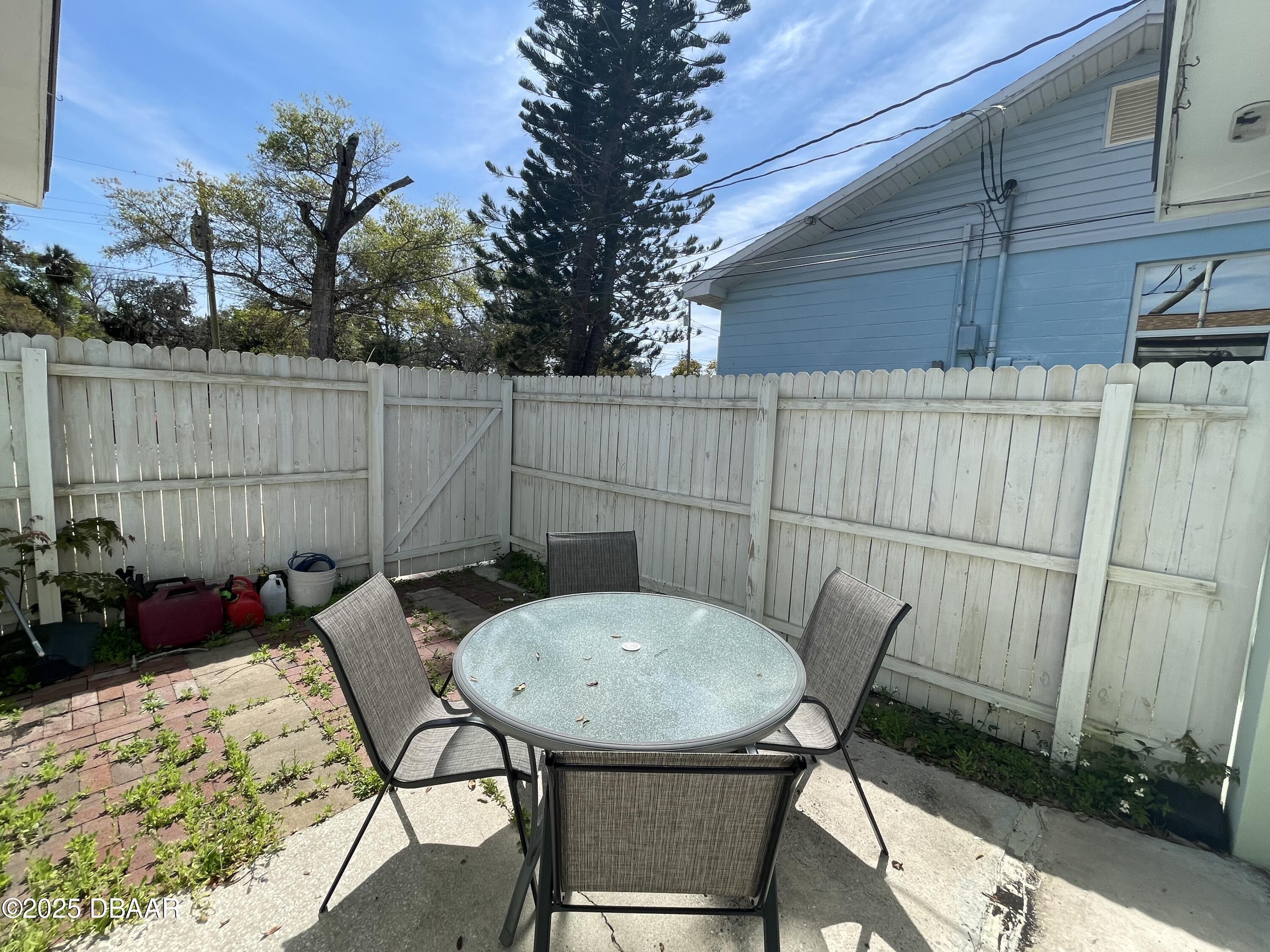 43 Warwick Avenue Ormond Beach, FL 32174 - Photo 20 of 32 a backyard of a house with table and chairs