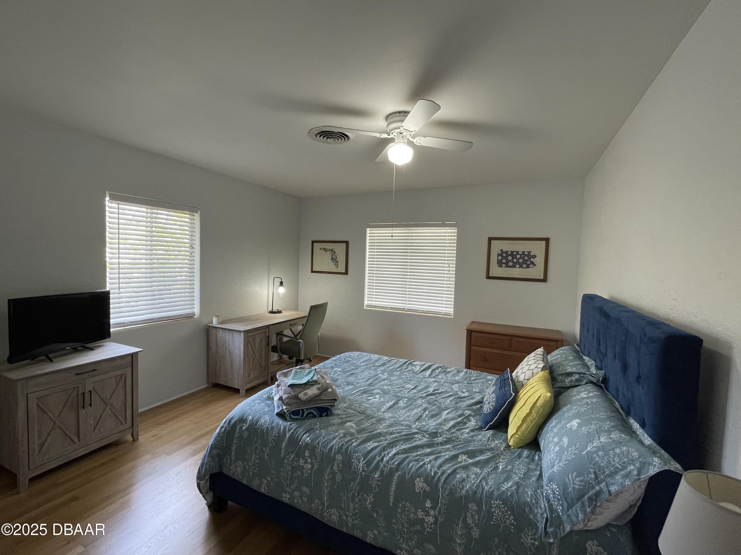 43 Warwick Avenue Ormond Beach, FL 32174 - Photo 22 of 32 a bedroom with a bed and wooden floor