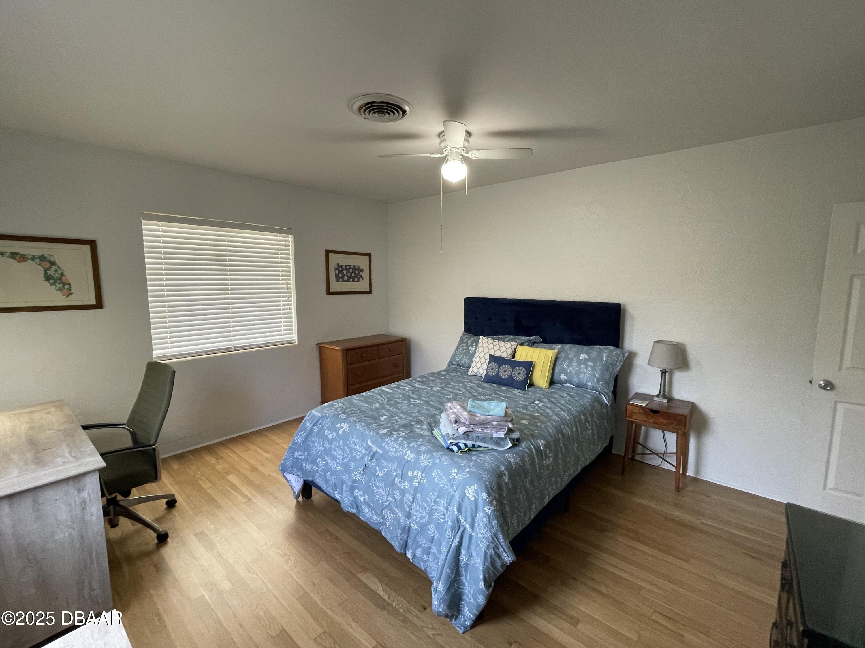 43 Warwick Avenue Ormond Beach, FL 32174 - Photo 23 of 32 a bedroom with a bed and a table in it