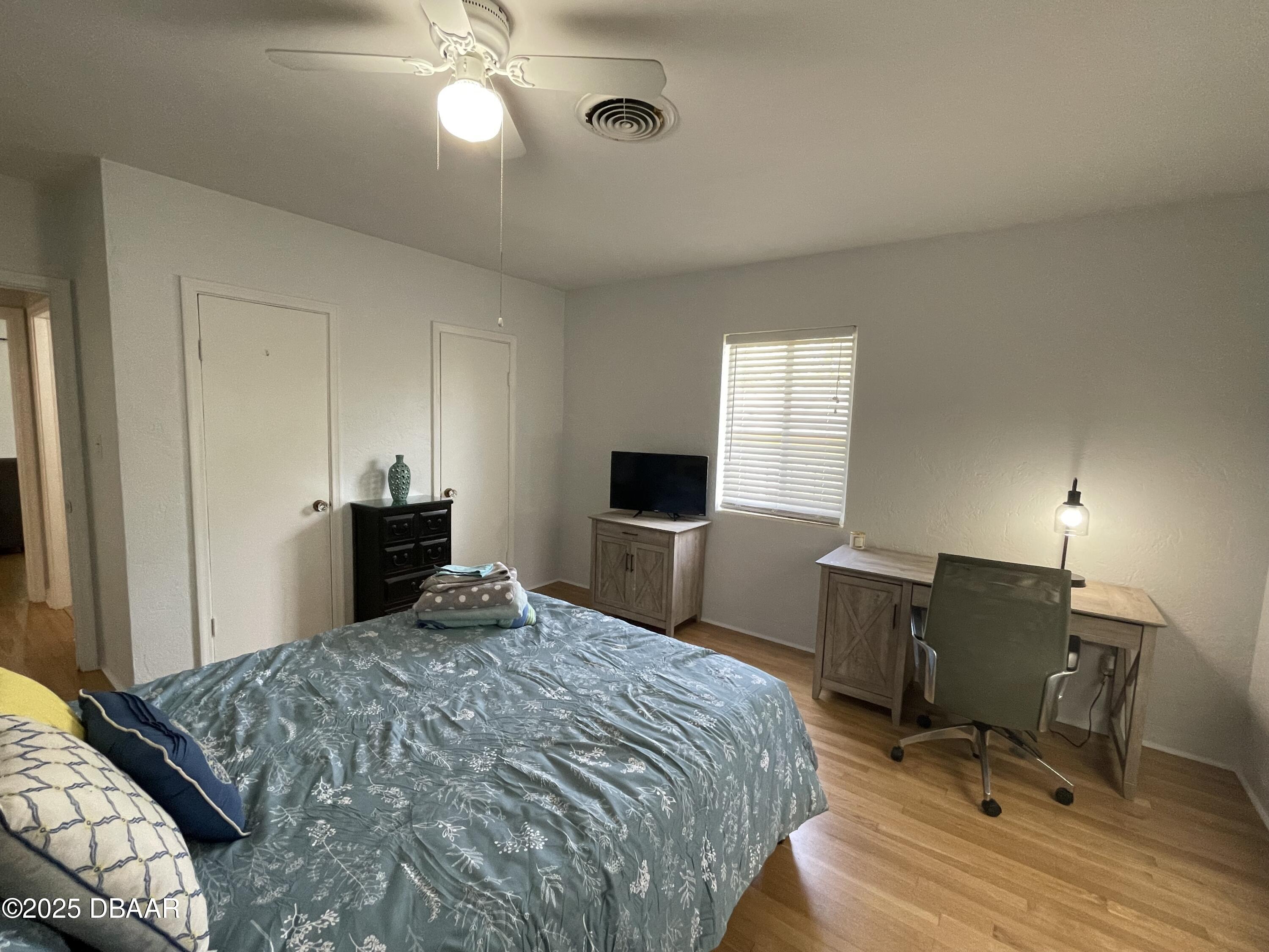 43 Warwick Avenue Ormond Beach, FL 32174 - Photo 24 of 32 a bedroom with a bed and a desk