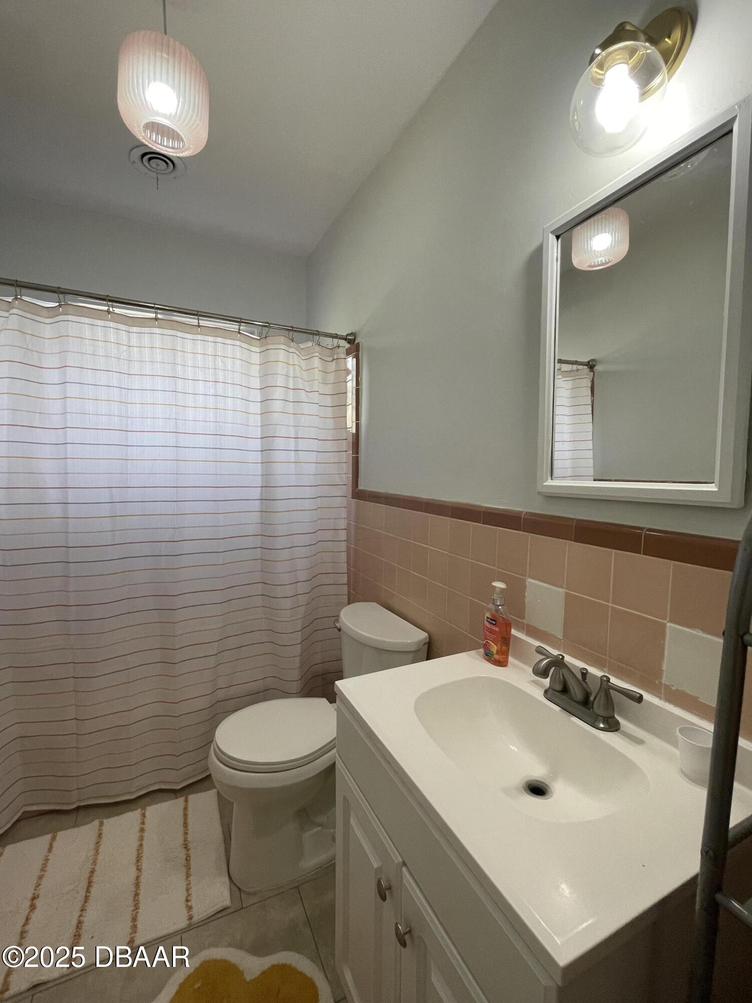43 Warwick Avenue Ormond Beach, FL 32174 - Photo 25 of 32 a bathroom with a sink a toilet and mirror