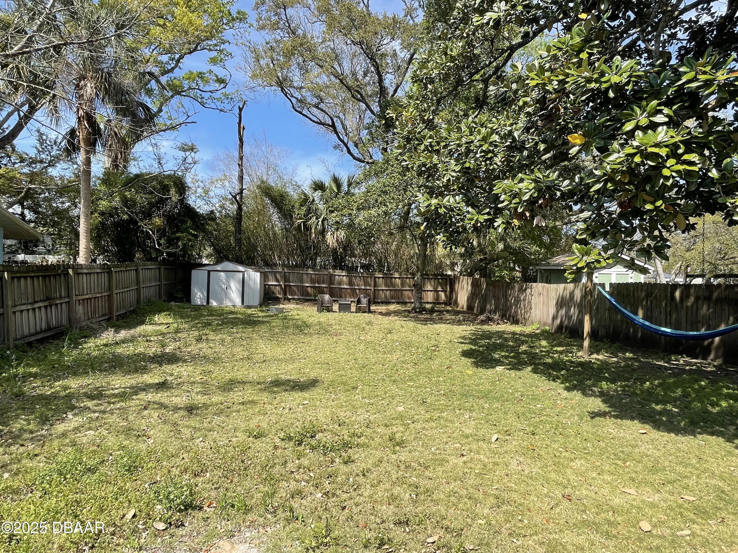 43 Warwick Avenue Ormond Beach, FL 32174 - Photo 30 of 32 a view of a garden with a bench
