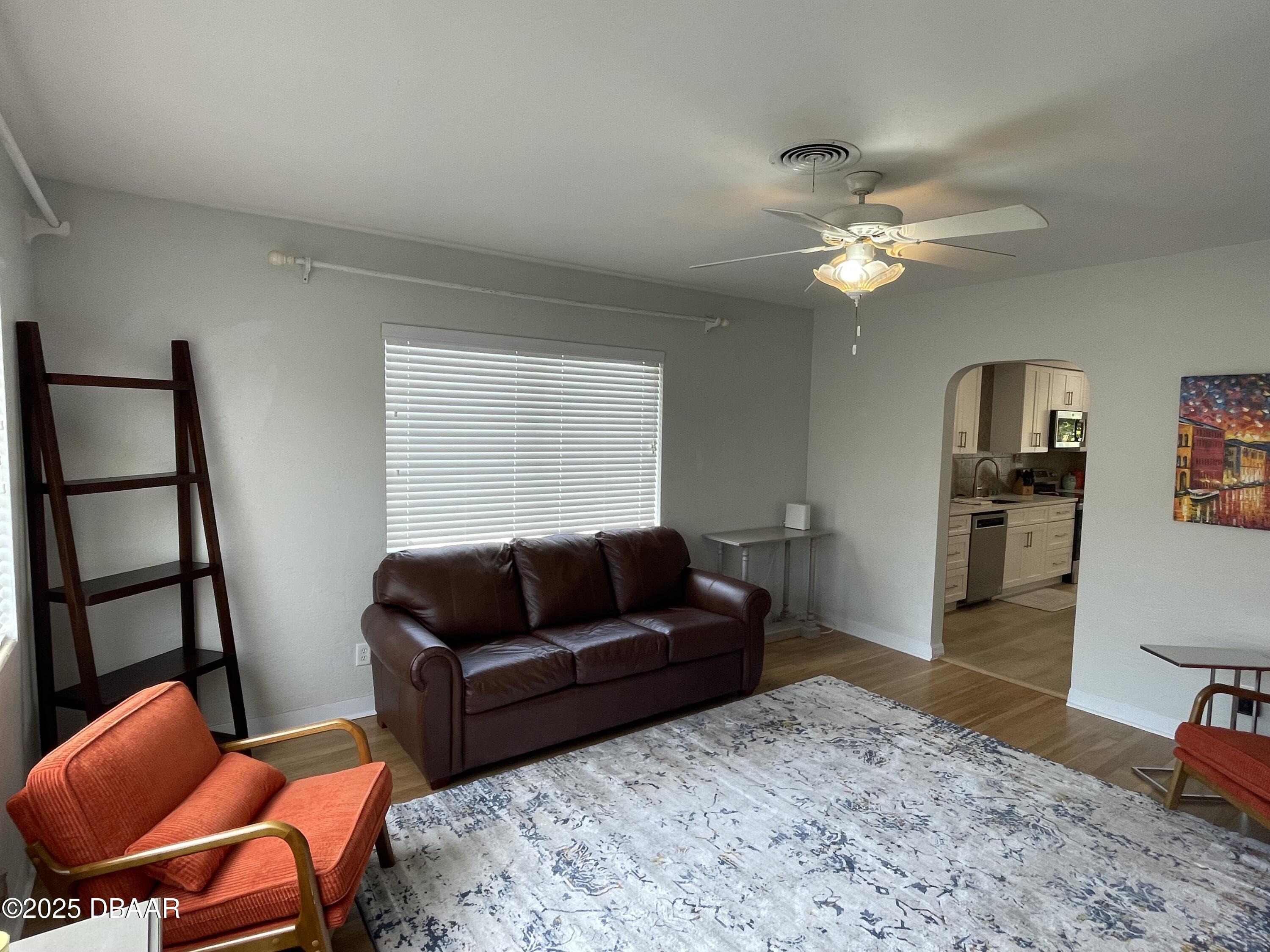 43 Warwick Avenue Ormond Beach, FL 32174 - Photo 3 of 32 a living room with furniture a ceiling fan and a rug