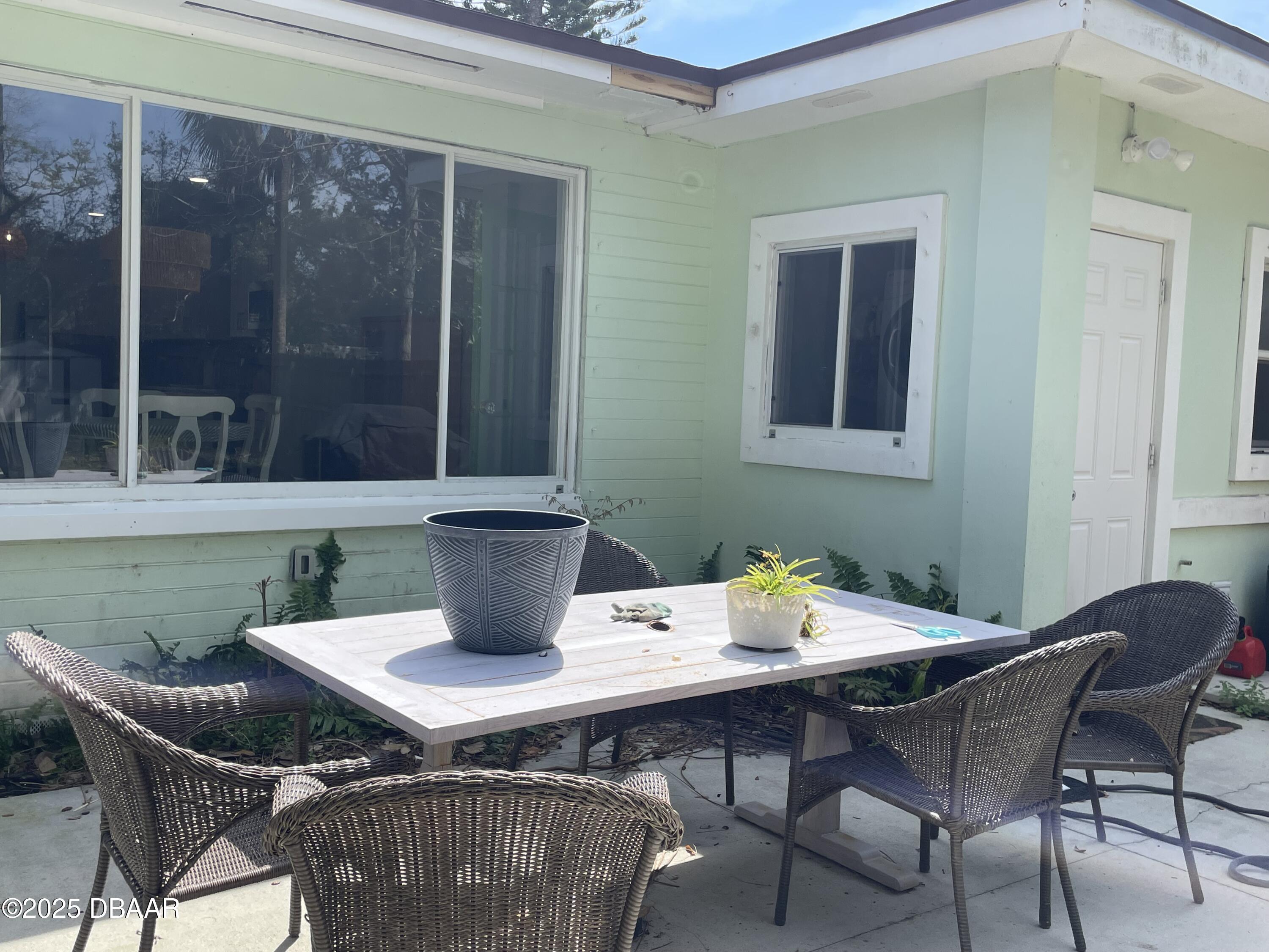 43 Warwick Avenue Ormond Beach, FL 32174 - Photo 32 of 32 a view of a dining table and chairs in the patio