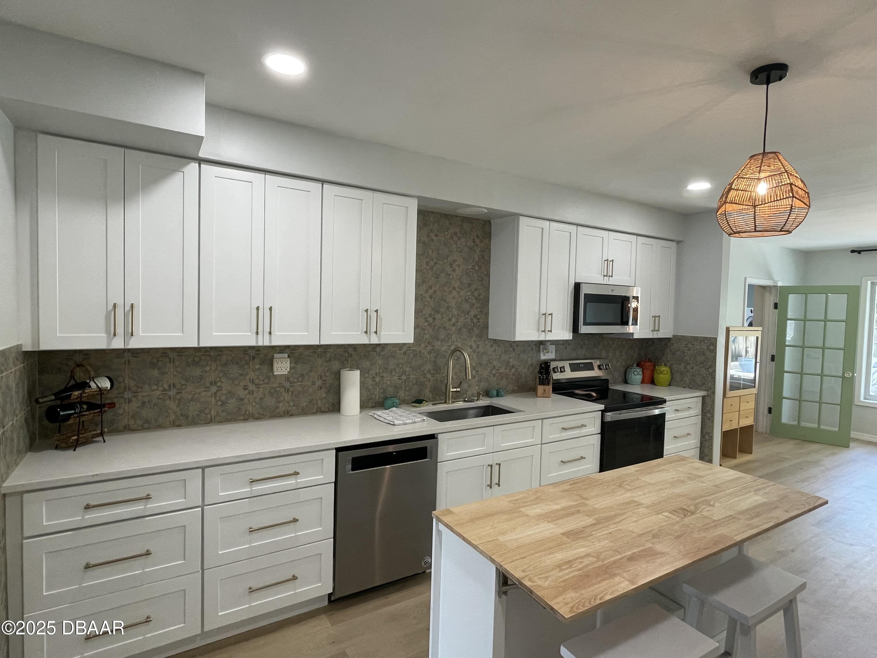 43 Warwick Avenue Ormond Beach, FL 32174 - Photo 6 of 32 a kitchen with granite countertop cabinets stainless steel appliances and a counter space