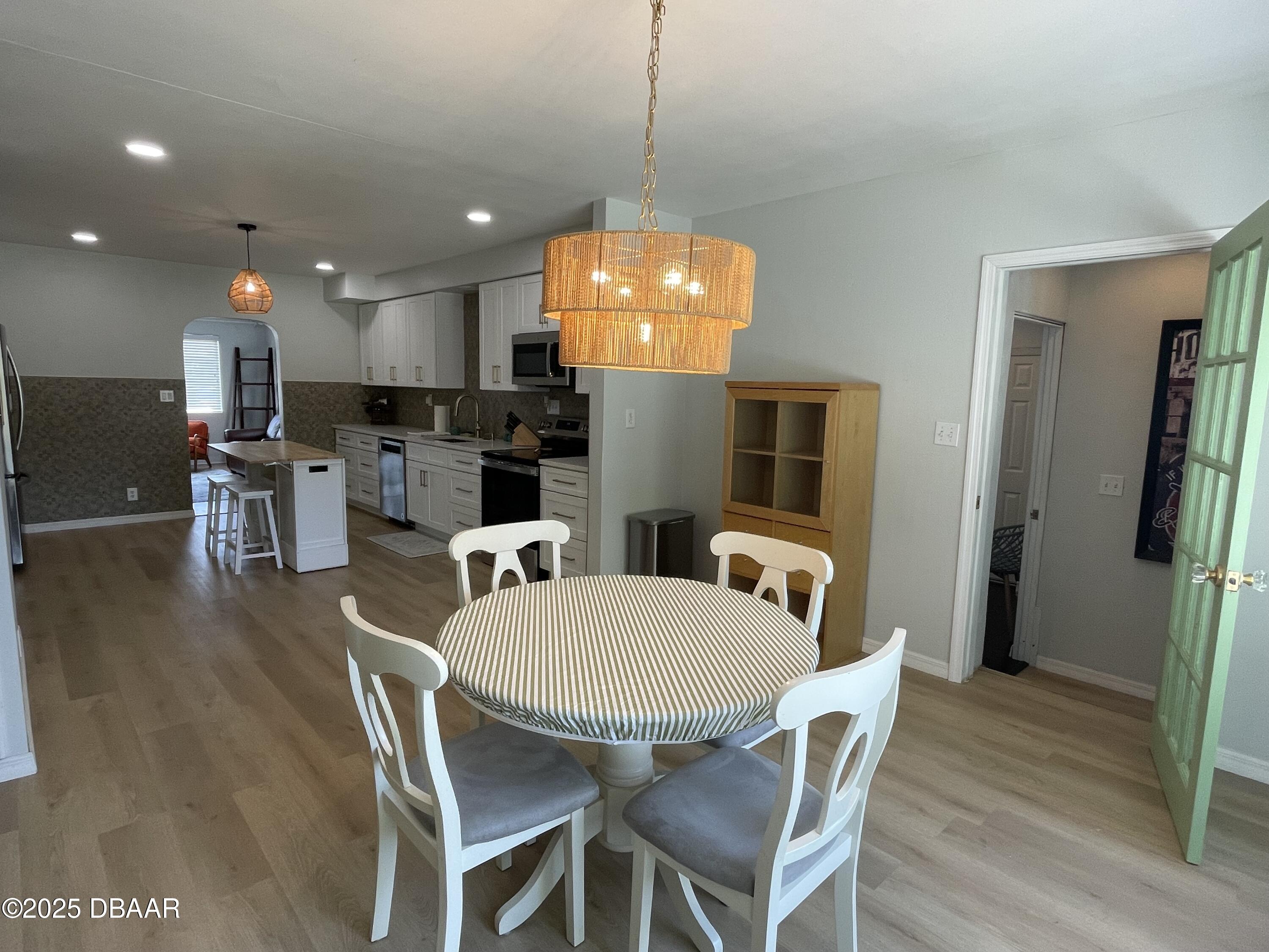 43 Warwick Avenue Ormond Beach, FL 32174 - Photo 10 of 32 a view of a dining room with furniture and wooden floor